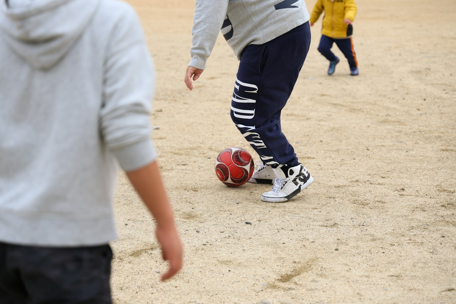 Active scene of children playing soccer with a ball being kicked
