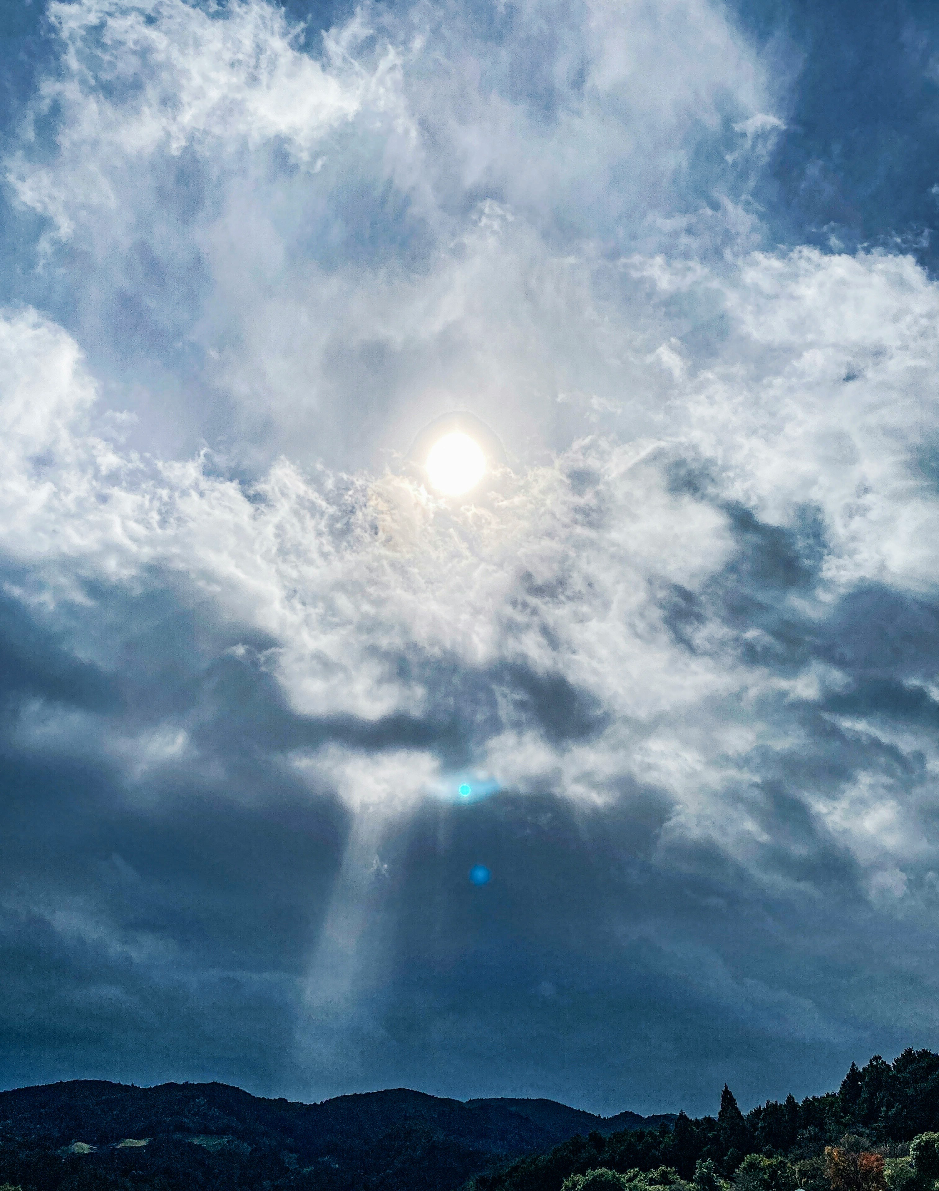 雨雲の間から差す秋の太陽光の放射