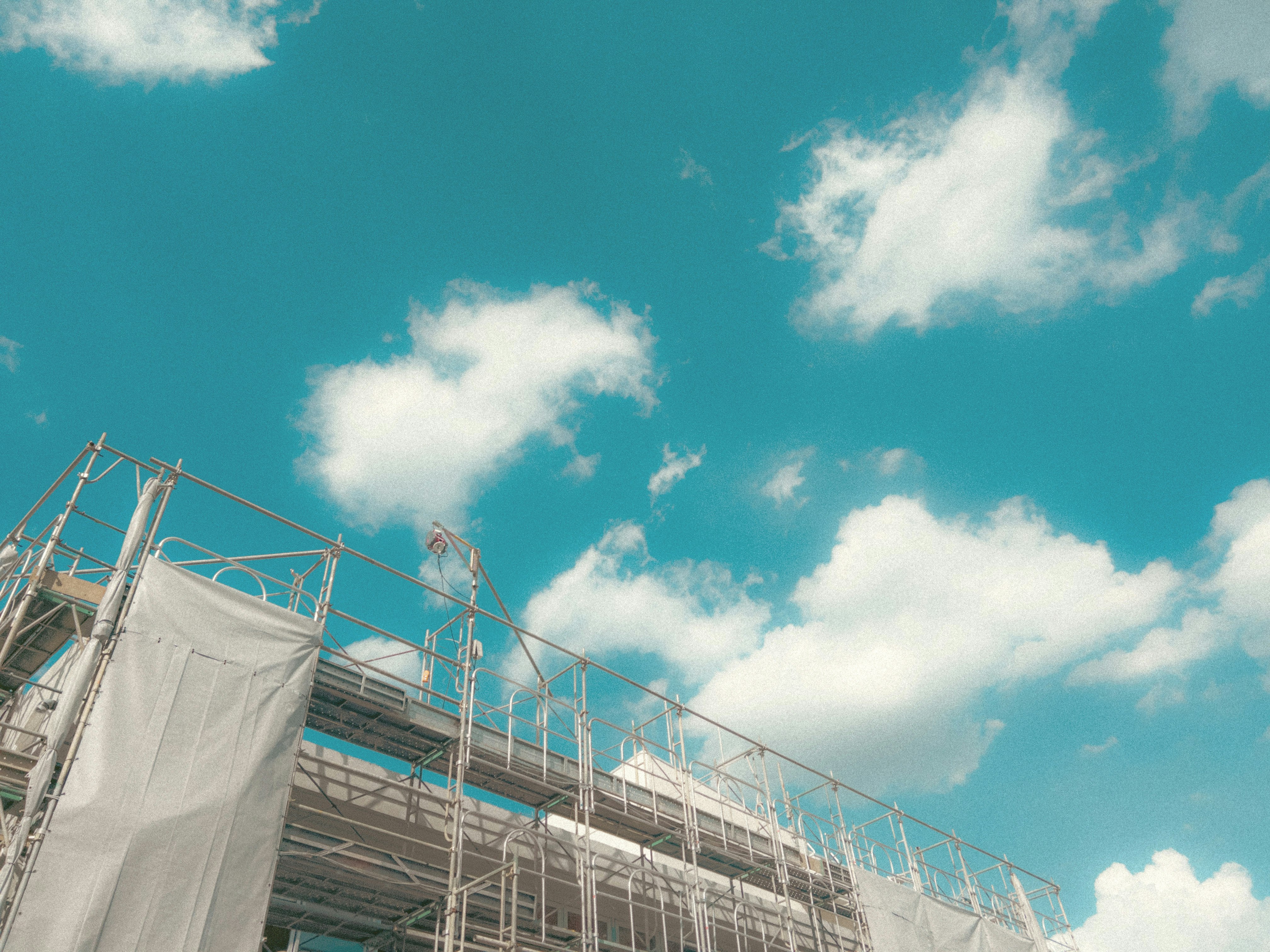 Construction site with scaffolding under a blue sky