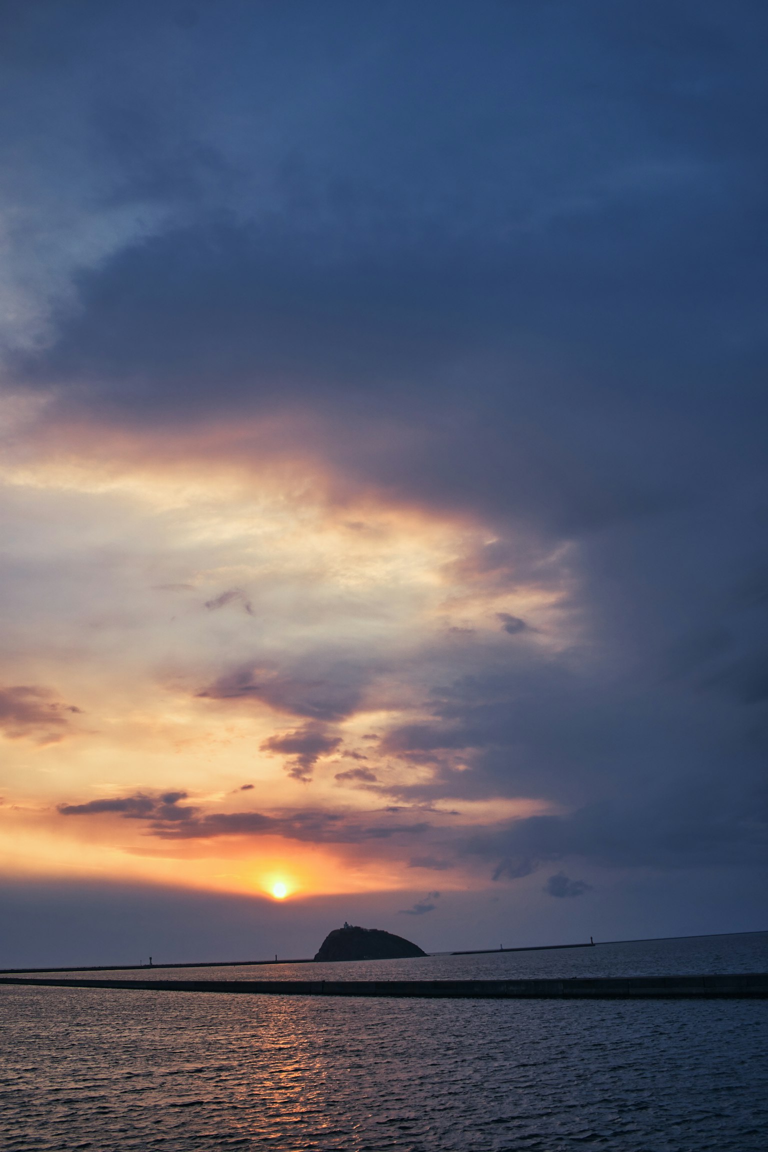 Beautiful landscape with sunset over the ocean and cloud formations