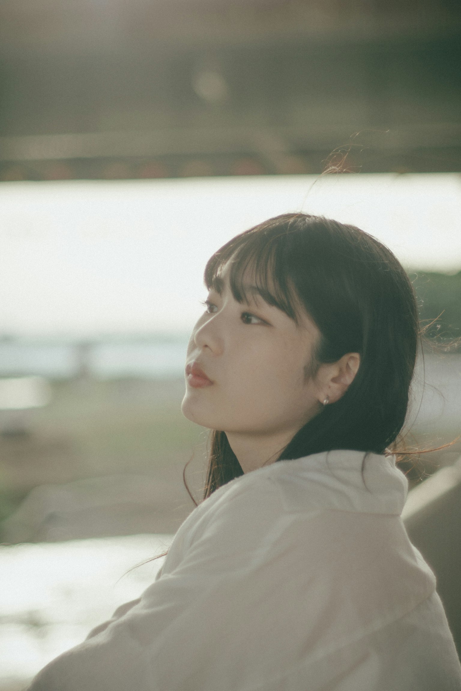 Side profile of a woman lost in thought bathed in soft light