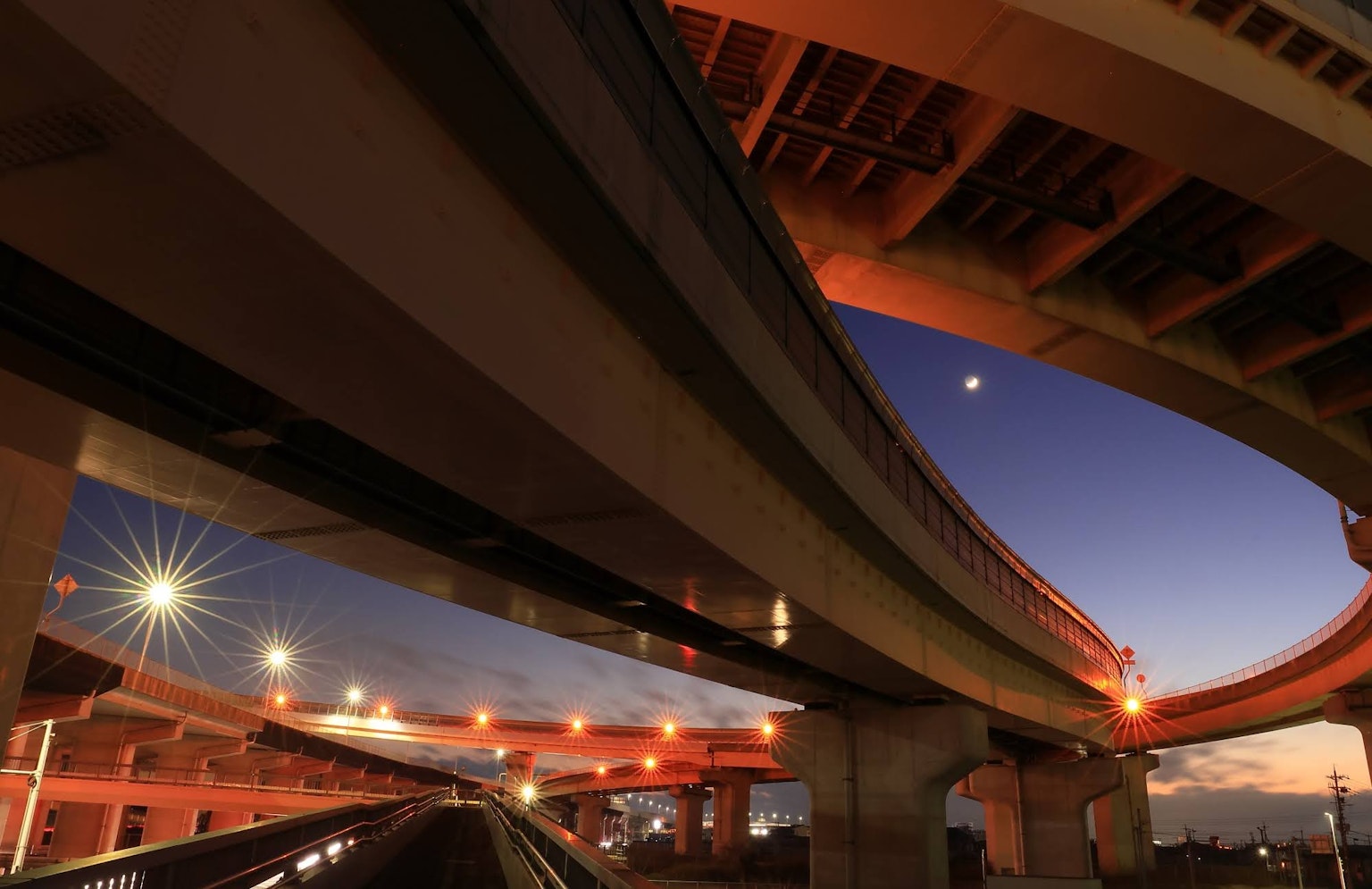 View of elevated highway at dusk showcasing curves and lighting