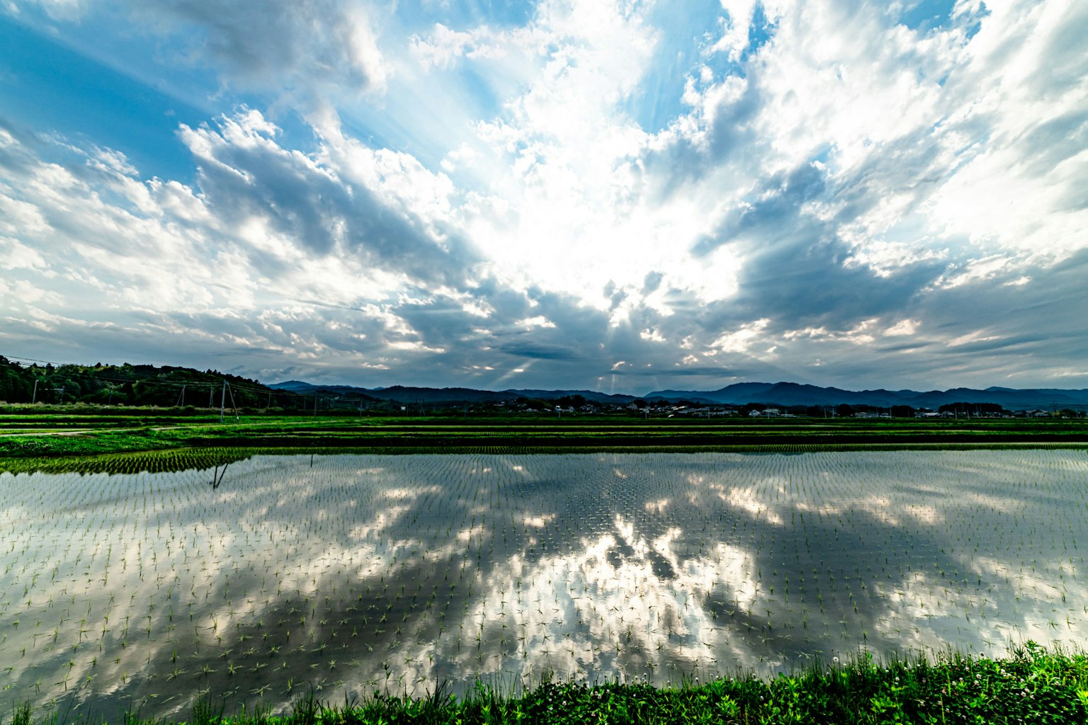 Beautiful landscape with blue sky and white clouds River reflecting clouds and greenery