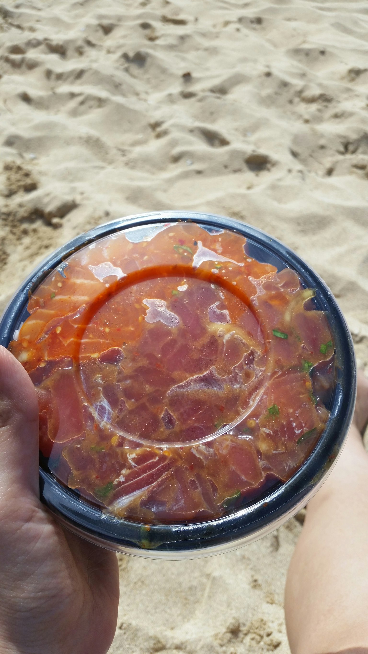 해변에서 들고 있는 신선한 사시미 용기