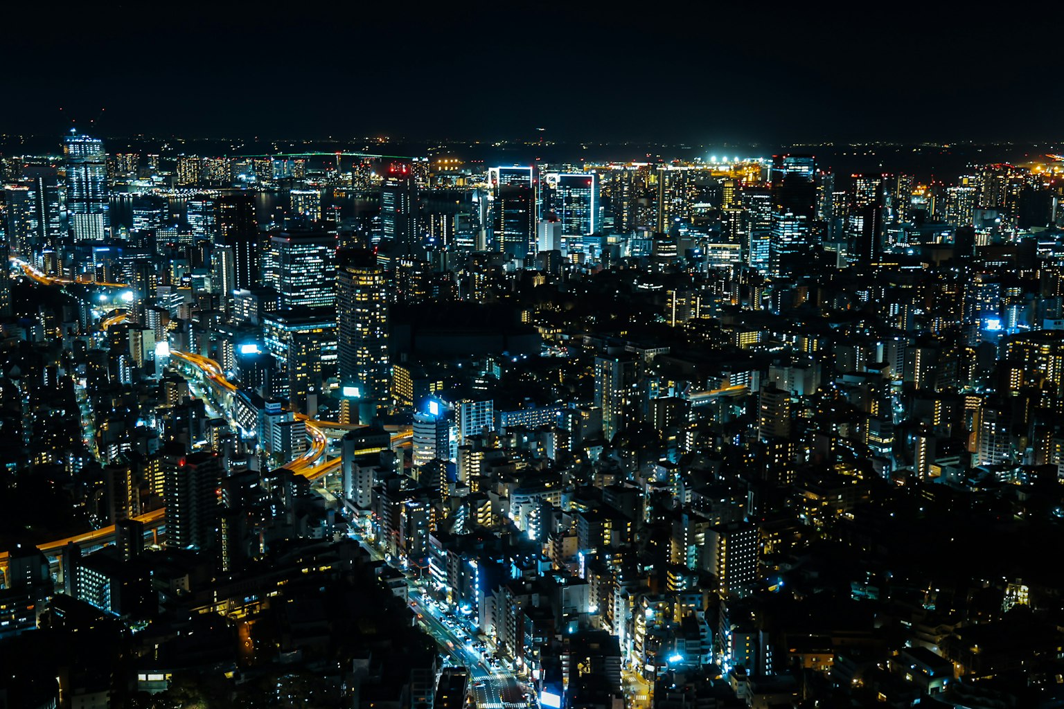 Impresionante vista nocturna de un horizonte urbano con rascacielos iluminados y calles