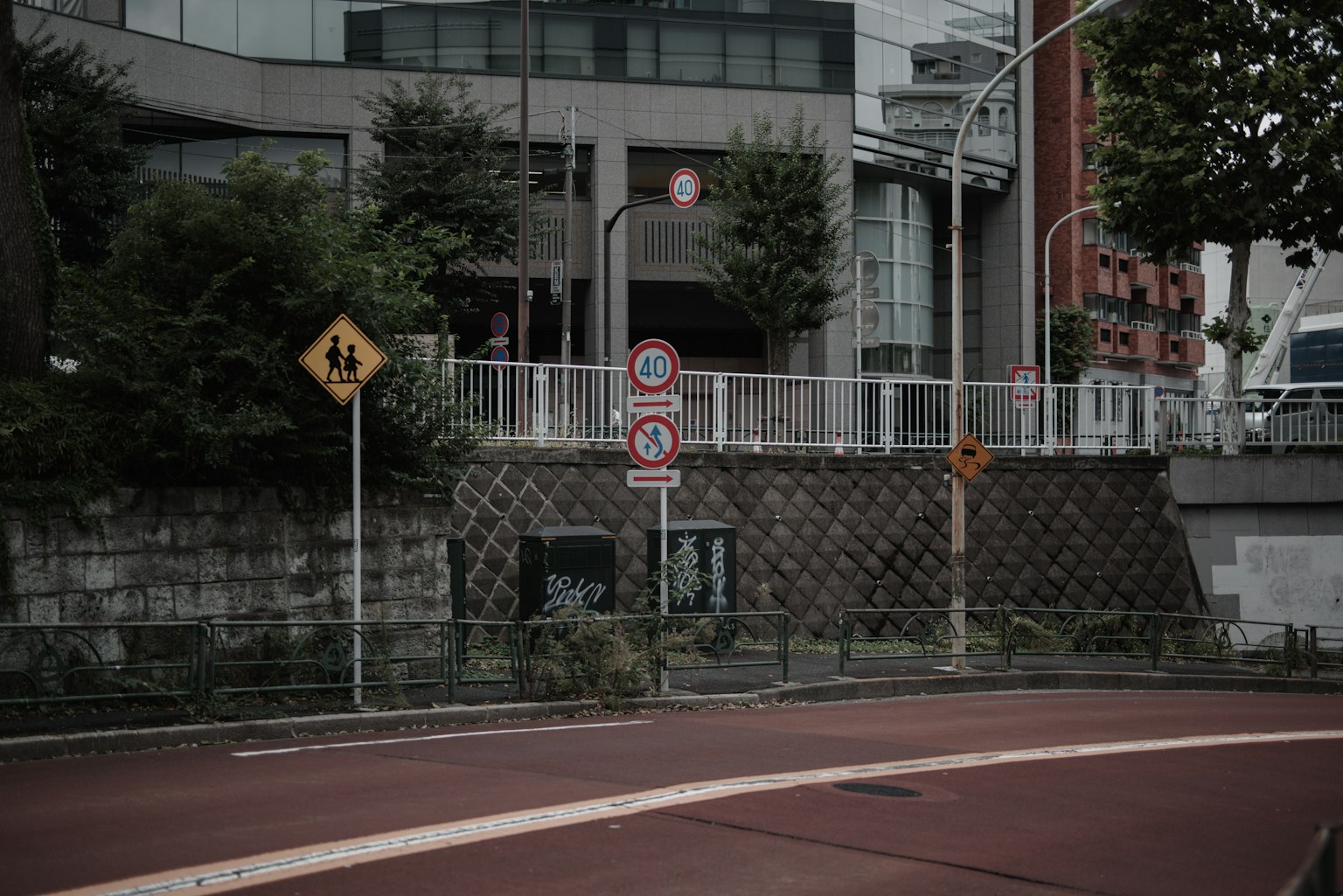 Urban scene featuring road signs and a building