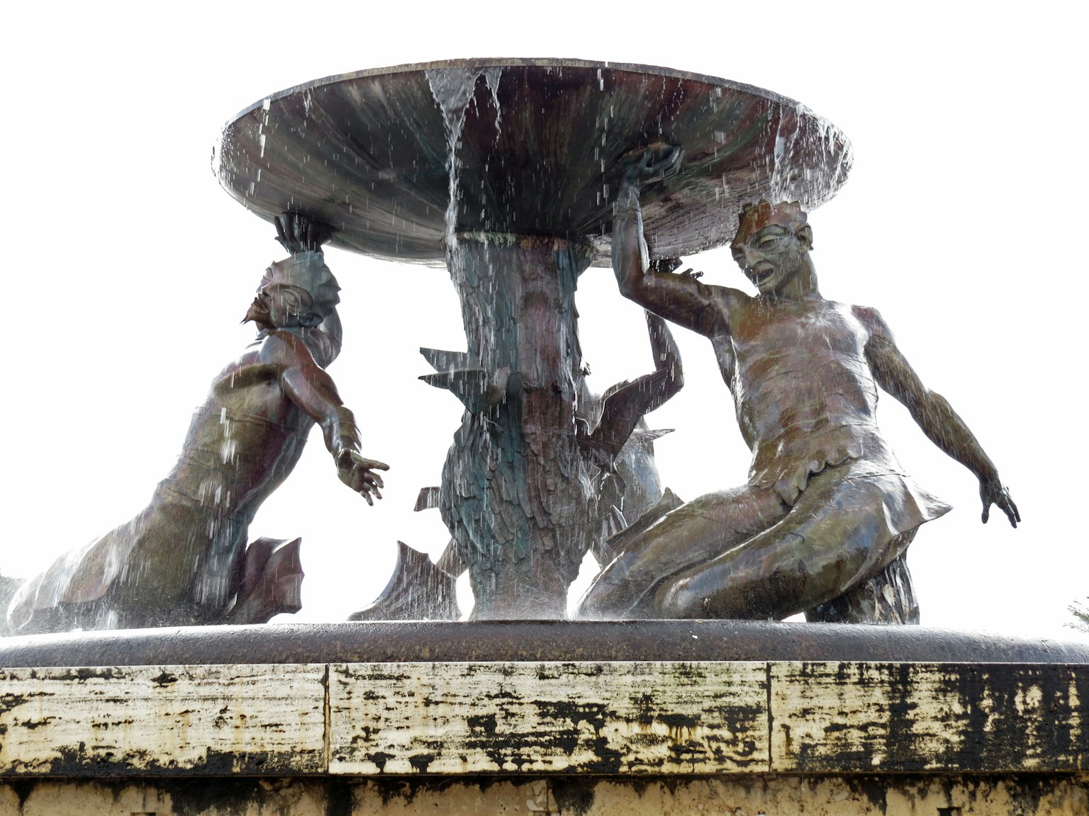 A fountain sculpture featuring two figures with flowing water