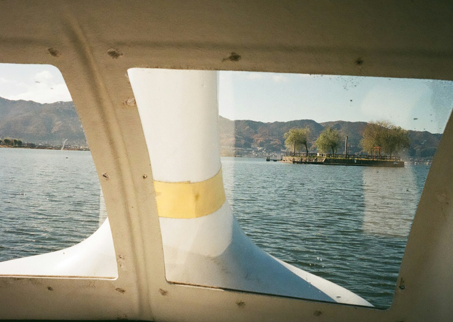 View from a seaplane window showing a lake and mountains