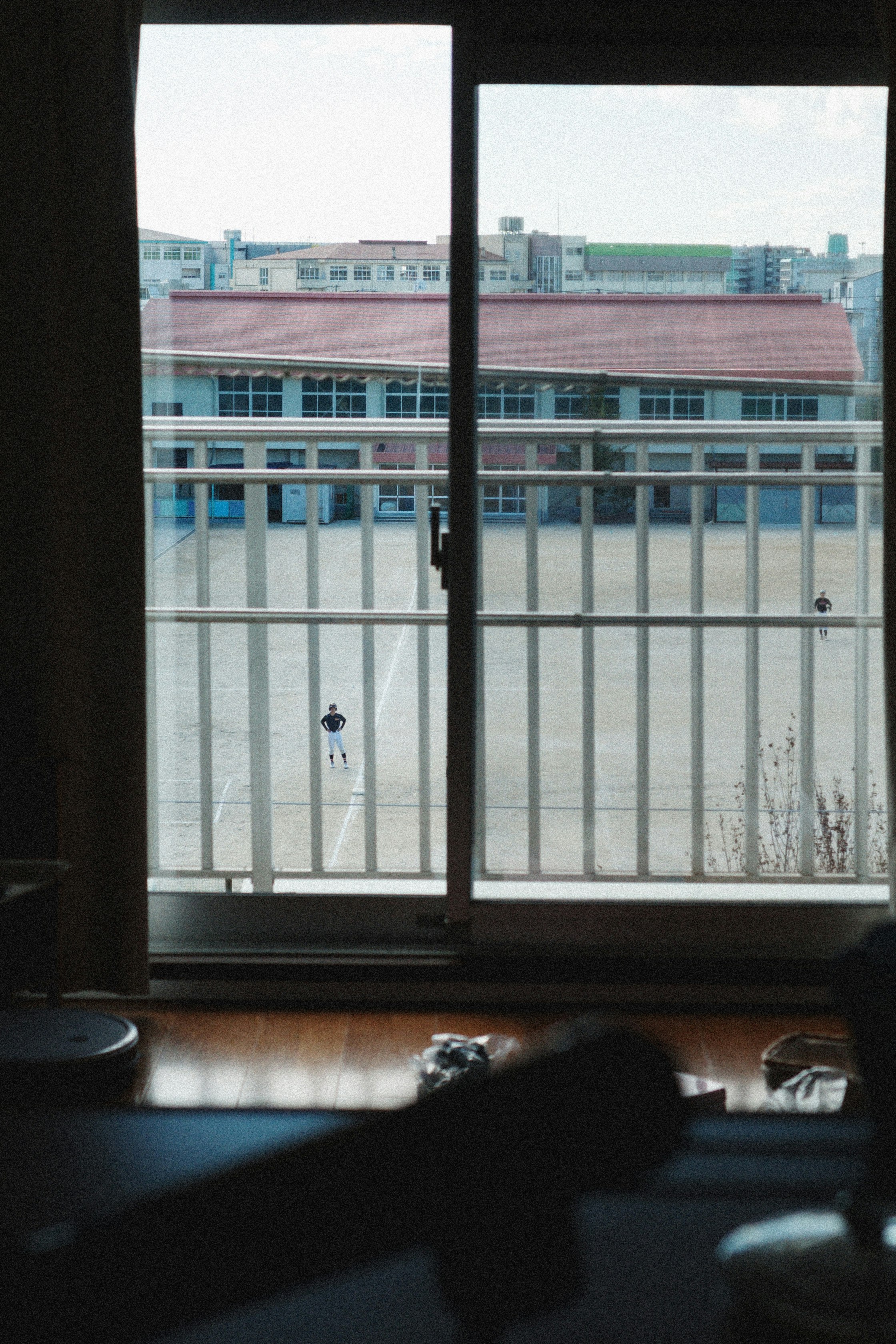 courtyard with school buildings seen through a window