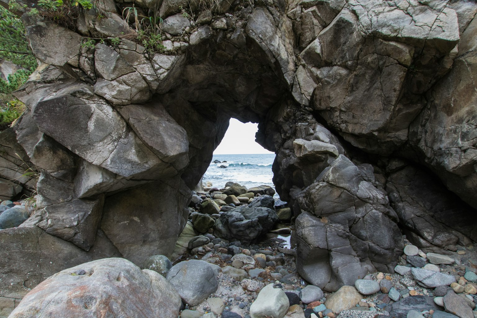 View of the sea through a rocky arch
