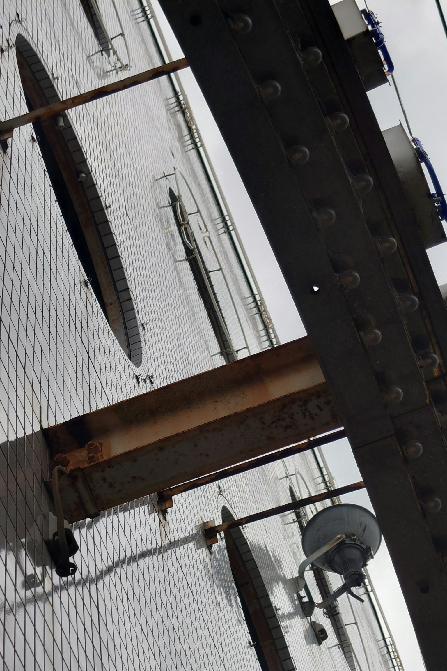 Metal devices and circular openings mounted on a white wall