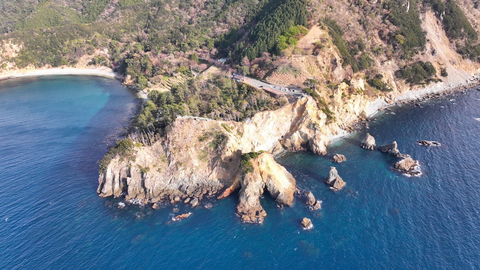 A stunning coastal landscape featuring cliffs surrounded by blue sea