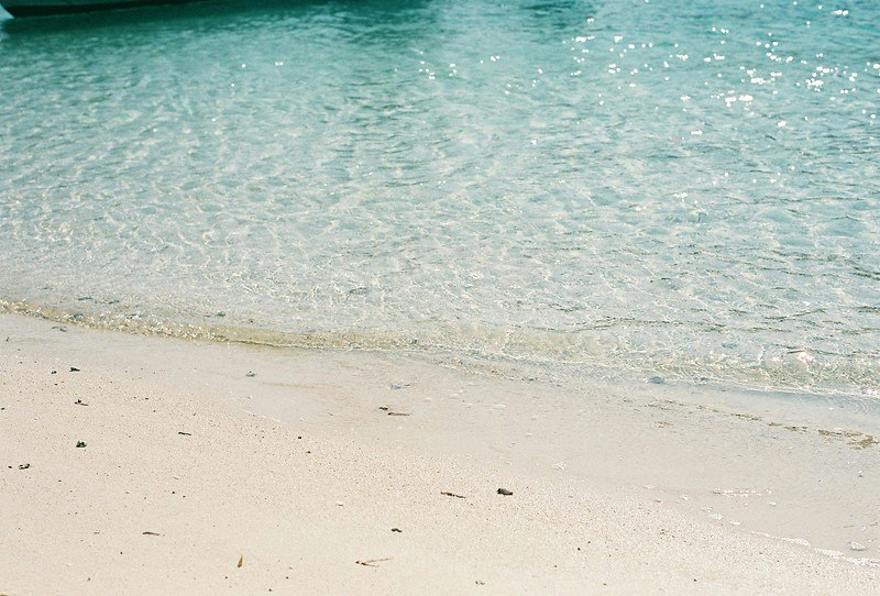 sandy beach shoreline with rippling sea water