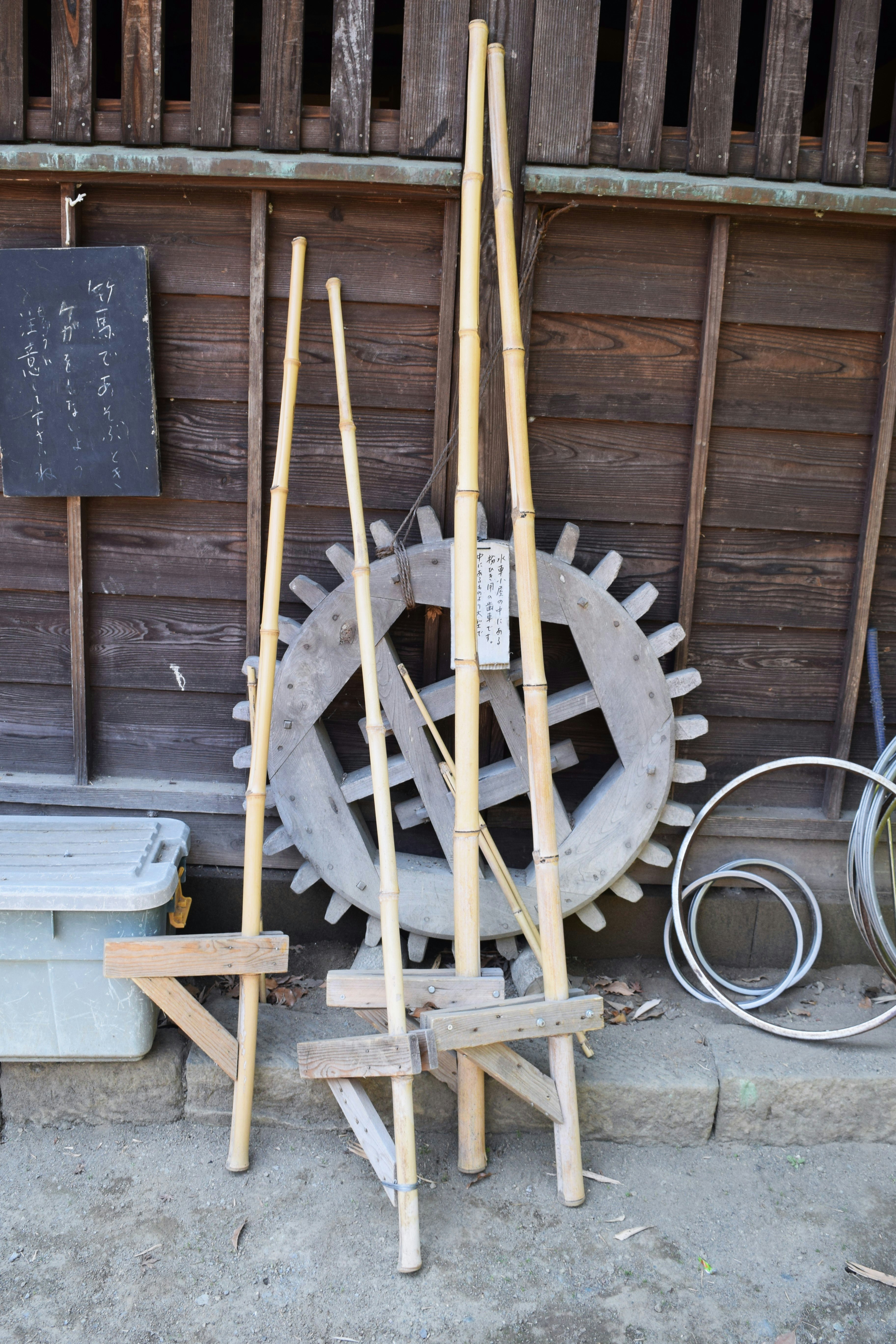 wooden waterwheel-like device placed by a traditional house wall
