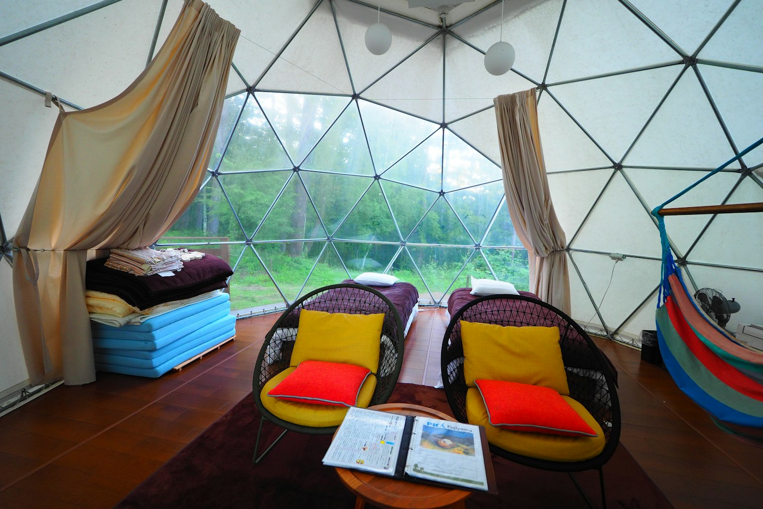 Colorful chairs and bedding in a transparent dome interior
