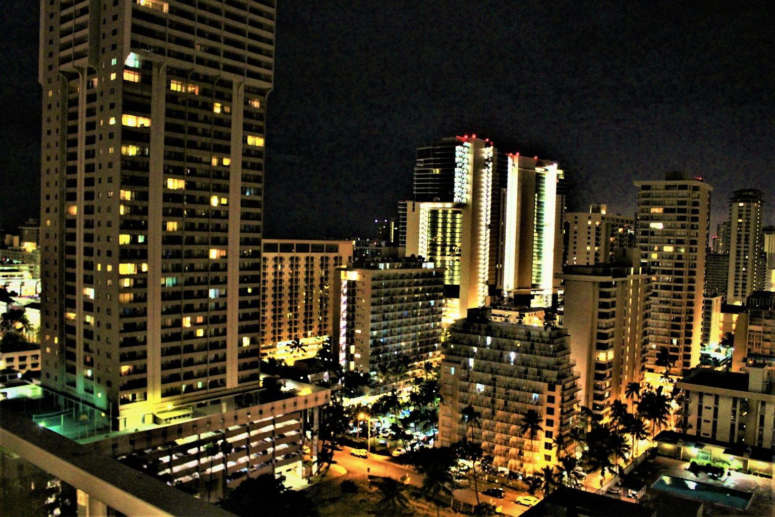 City skyline at night with illuminated buildings and streetlights