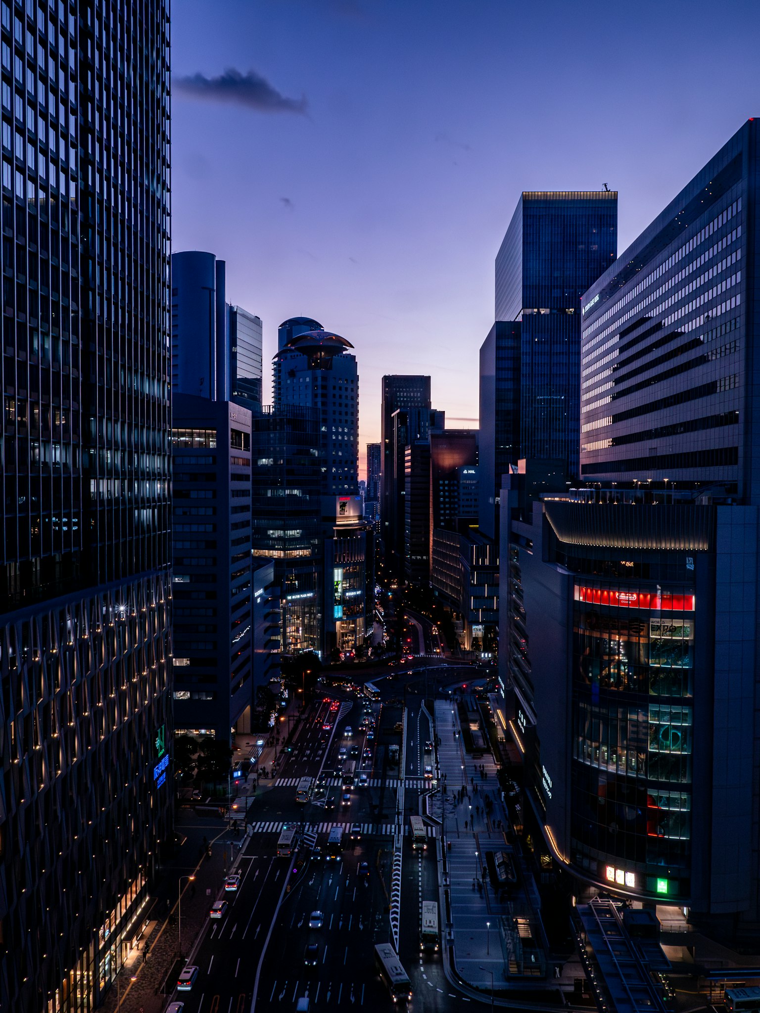 City skyline at dusk with skyscrapers and illuminated streets