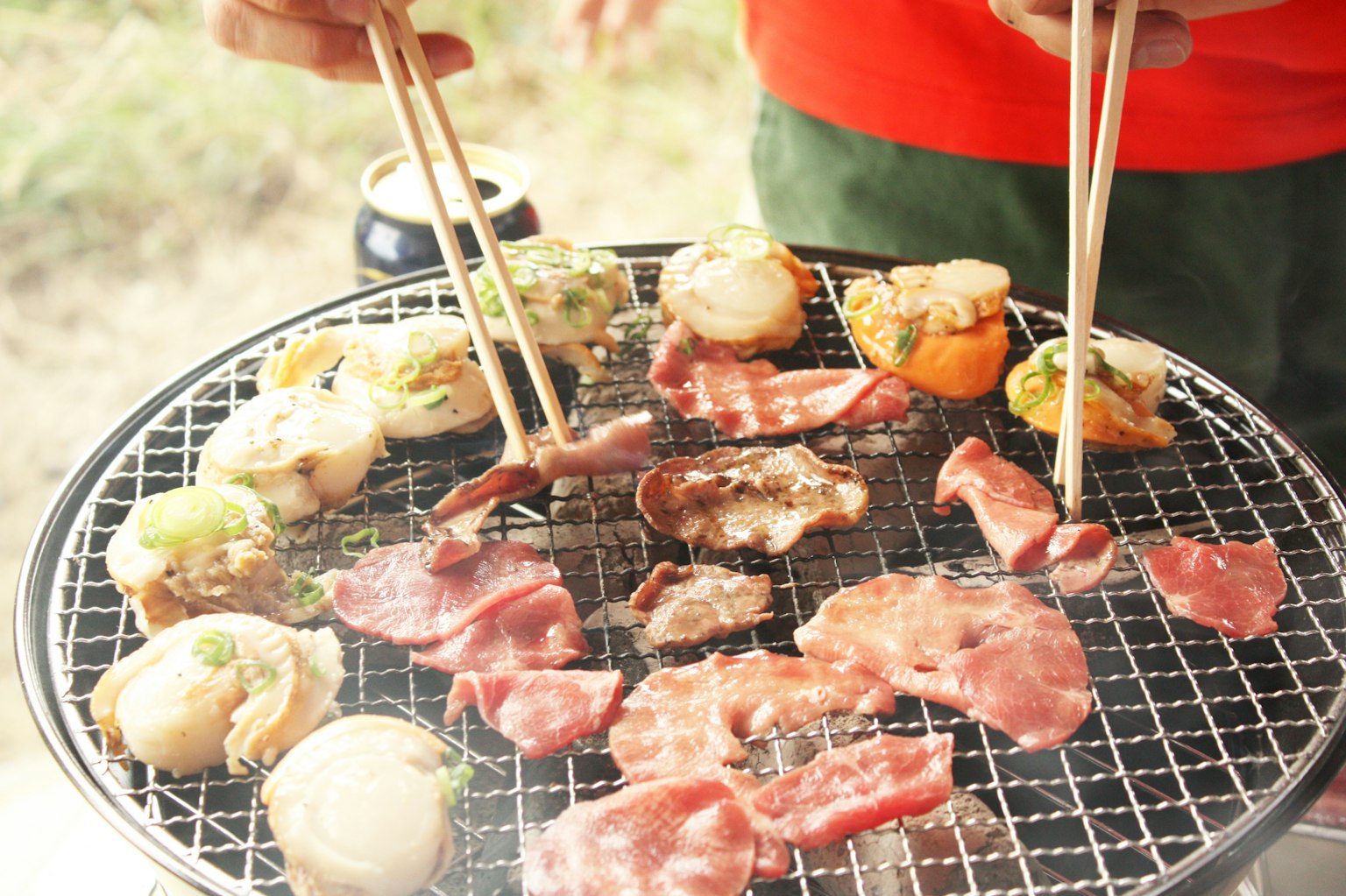 Scene of grilling meat and vegetables on a barbecue