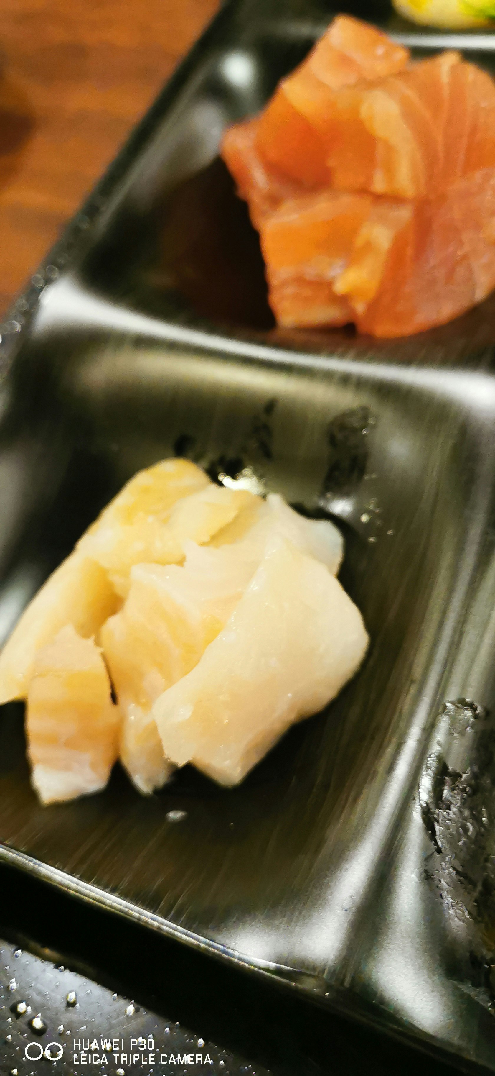sashimi of salmon and white fish on a metal tray