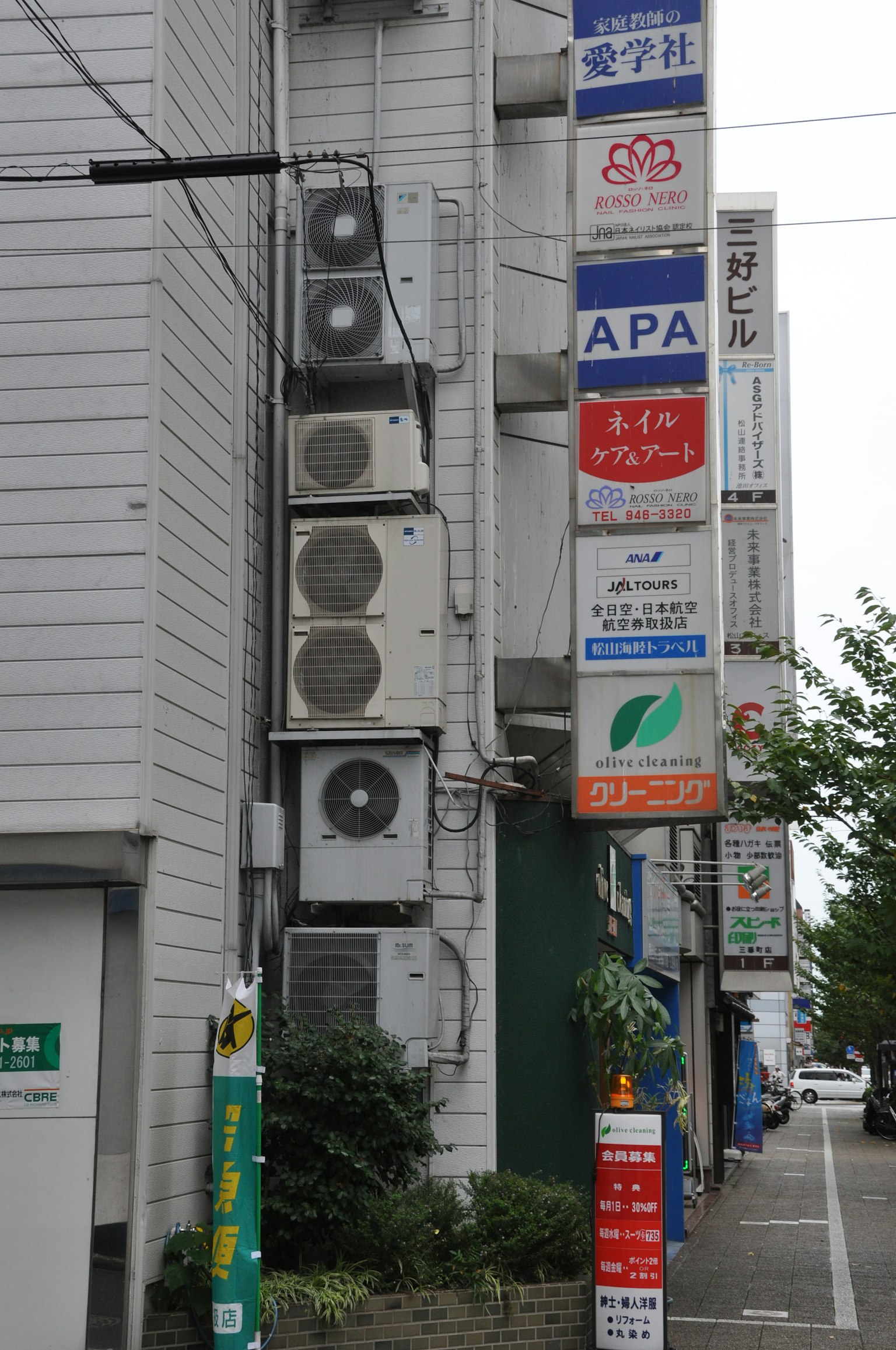 建筑侧面有多个空调和各种标志