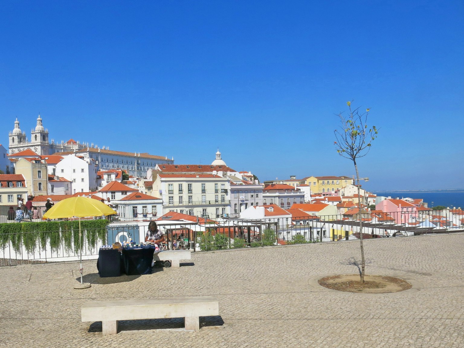 Lisbon cityscape with cafes and bright blue sky