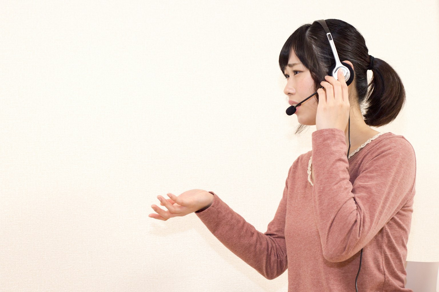 Woman speaking while wearing a headset