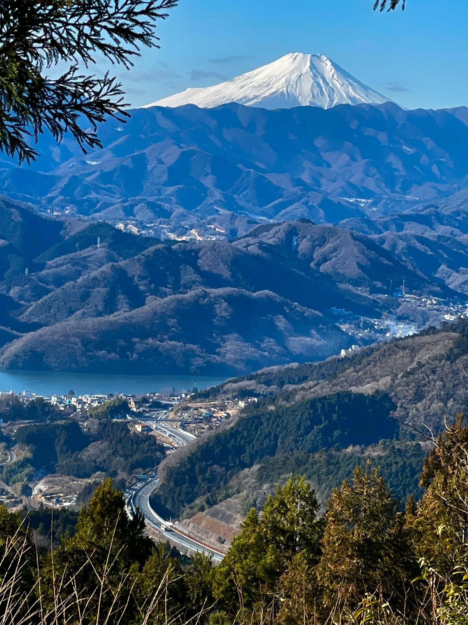Scenic view of Mount Fuji with surrounding mountains and a lake