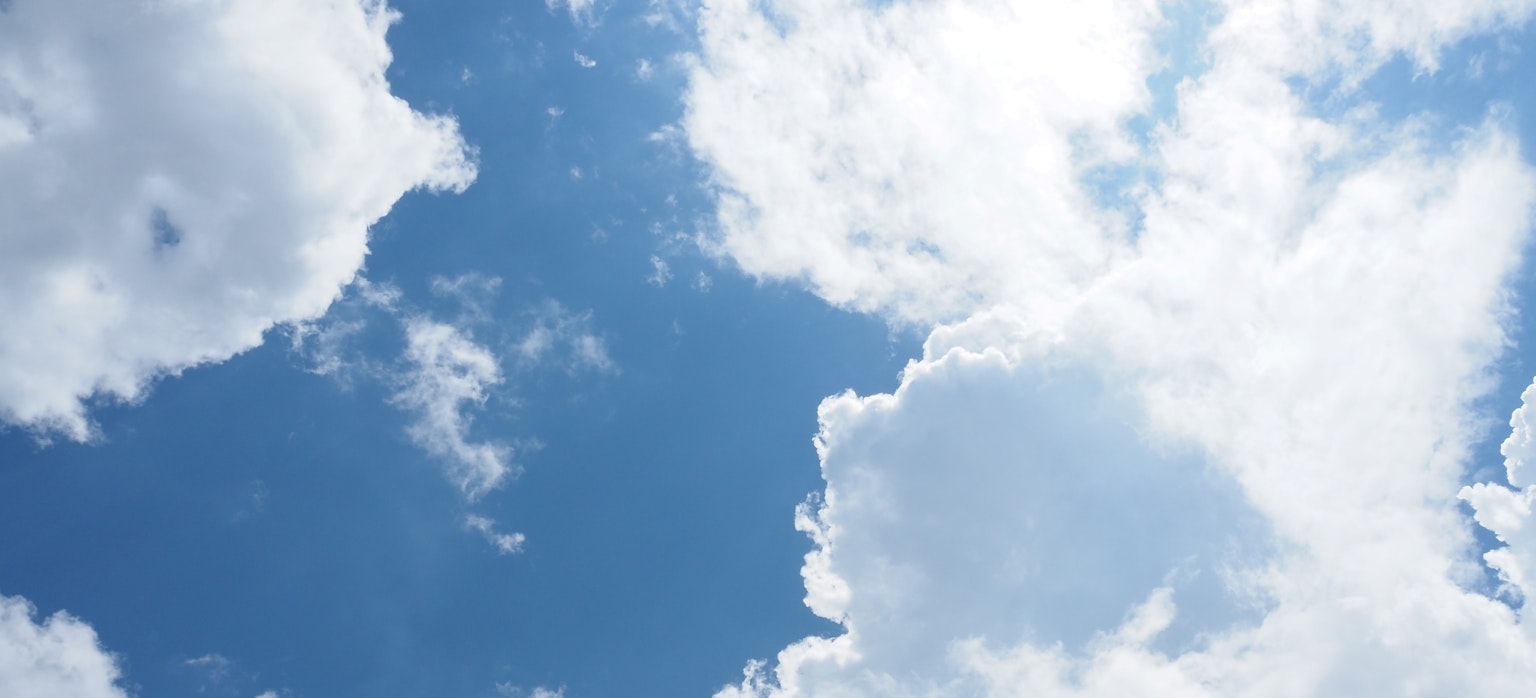 A bright blue sky filled with fluffy white clouds