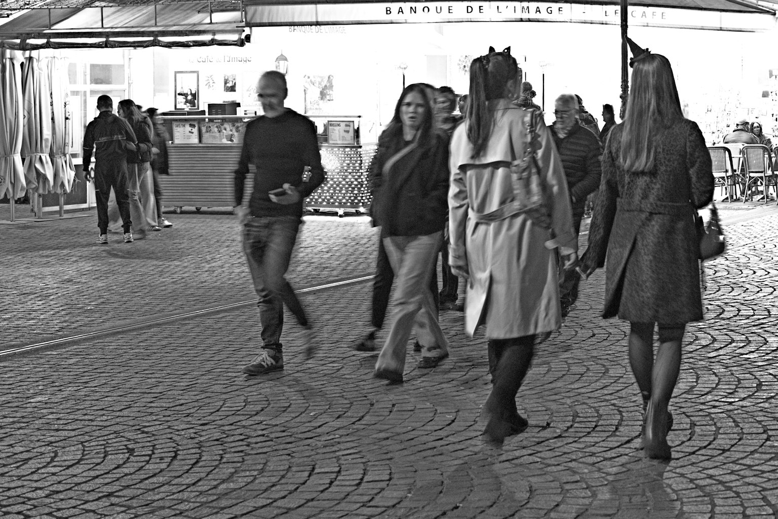 Photo en noir et blanc de personnes marchant dans la rue