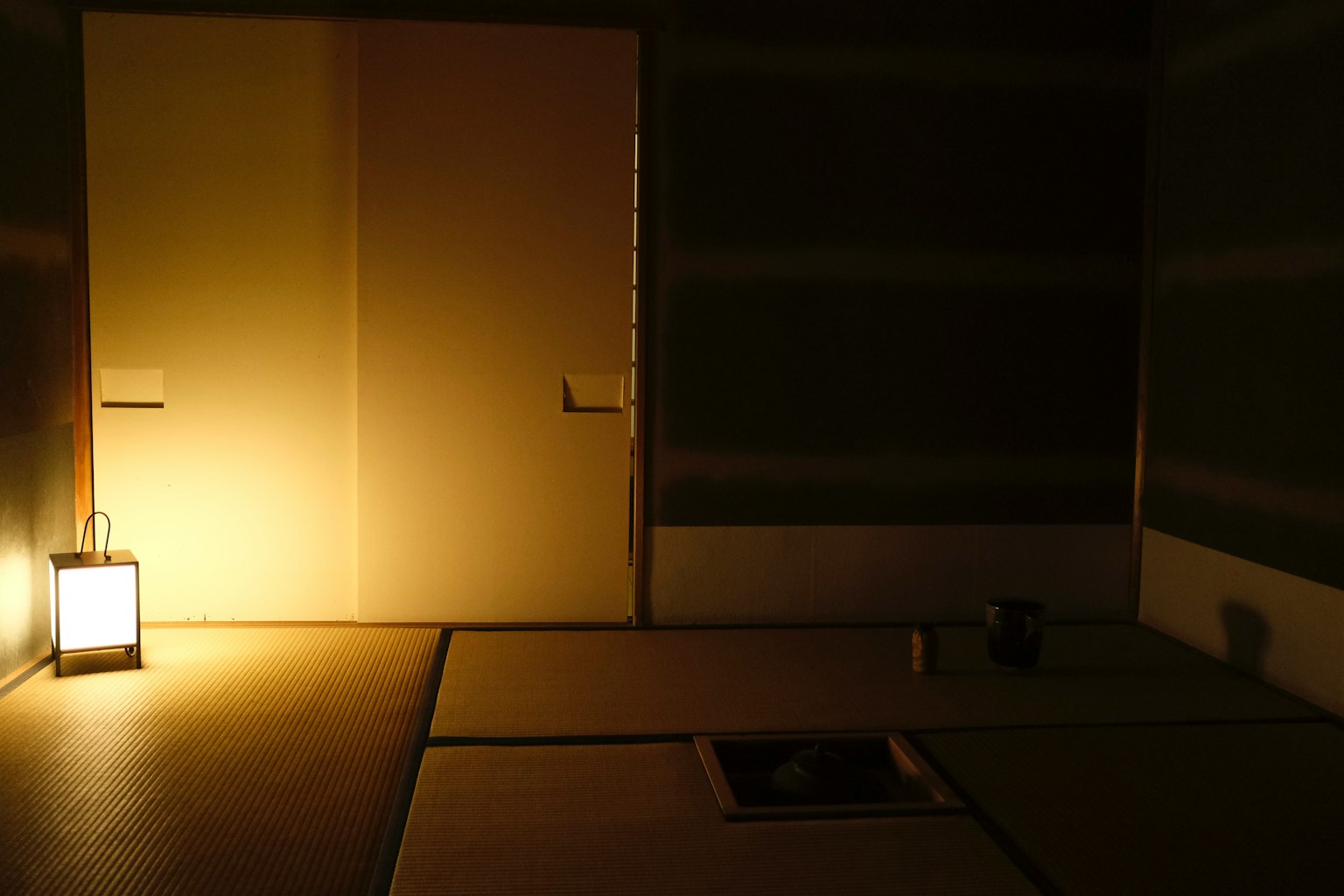 Dimly lit room with a lantern and sliding door