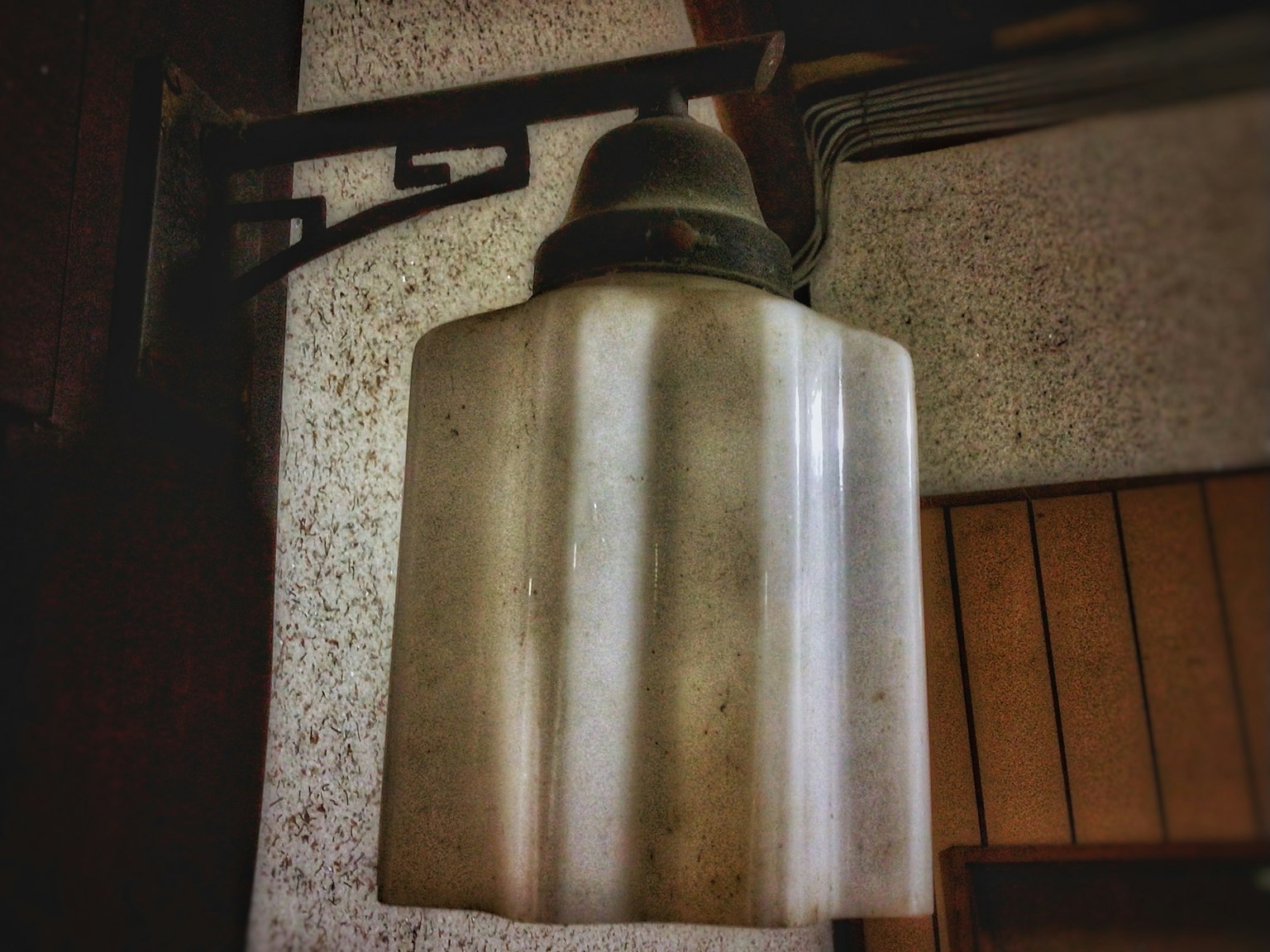 Vintage lamp shade mounted on a wall bracket