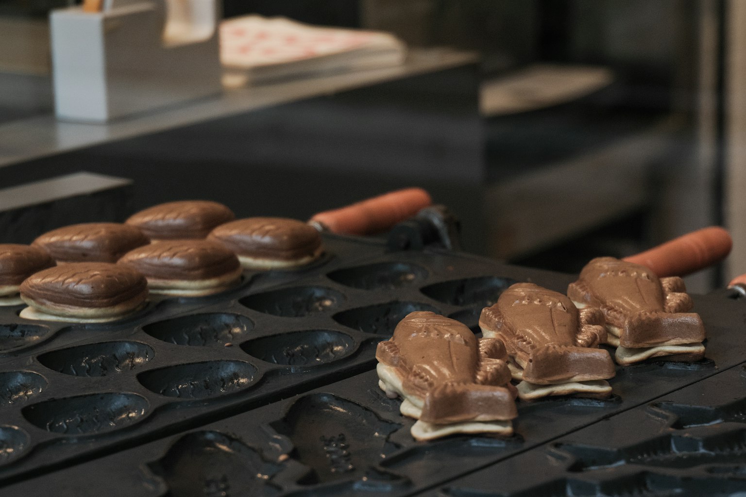 Fish-shaped pastries and round baked goods arranged on a tray