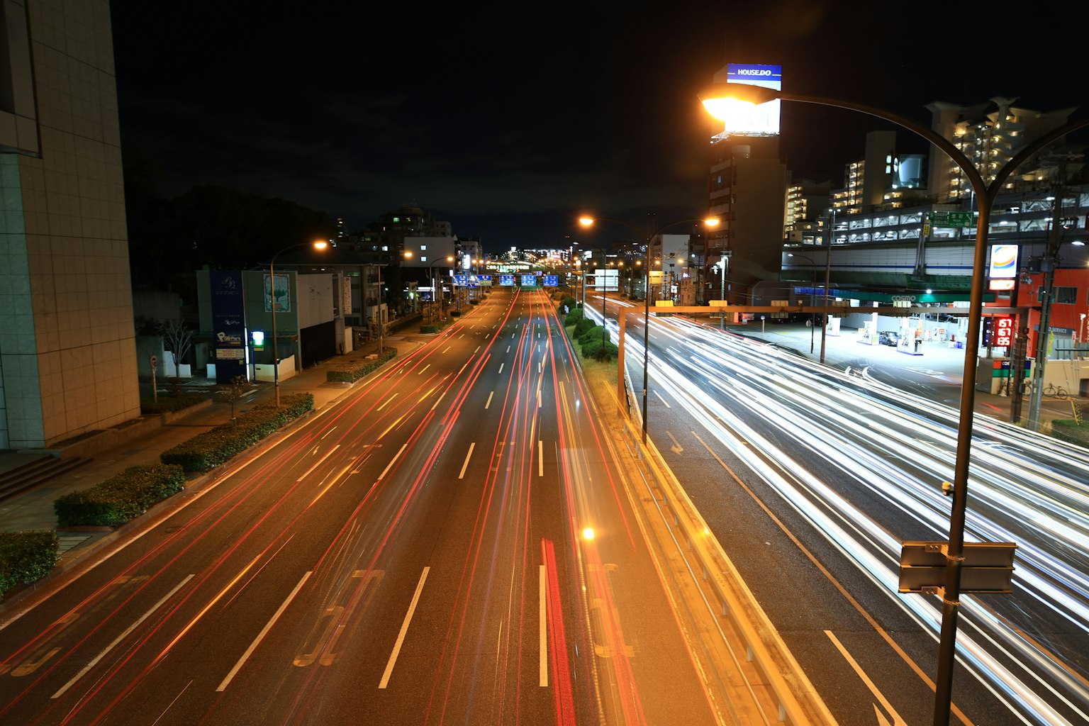 Nighttime city traffic with light trails and streetlights