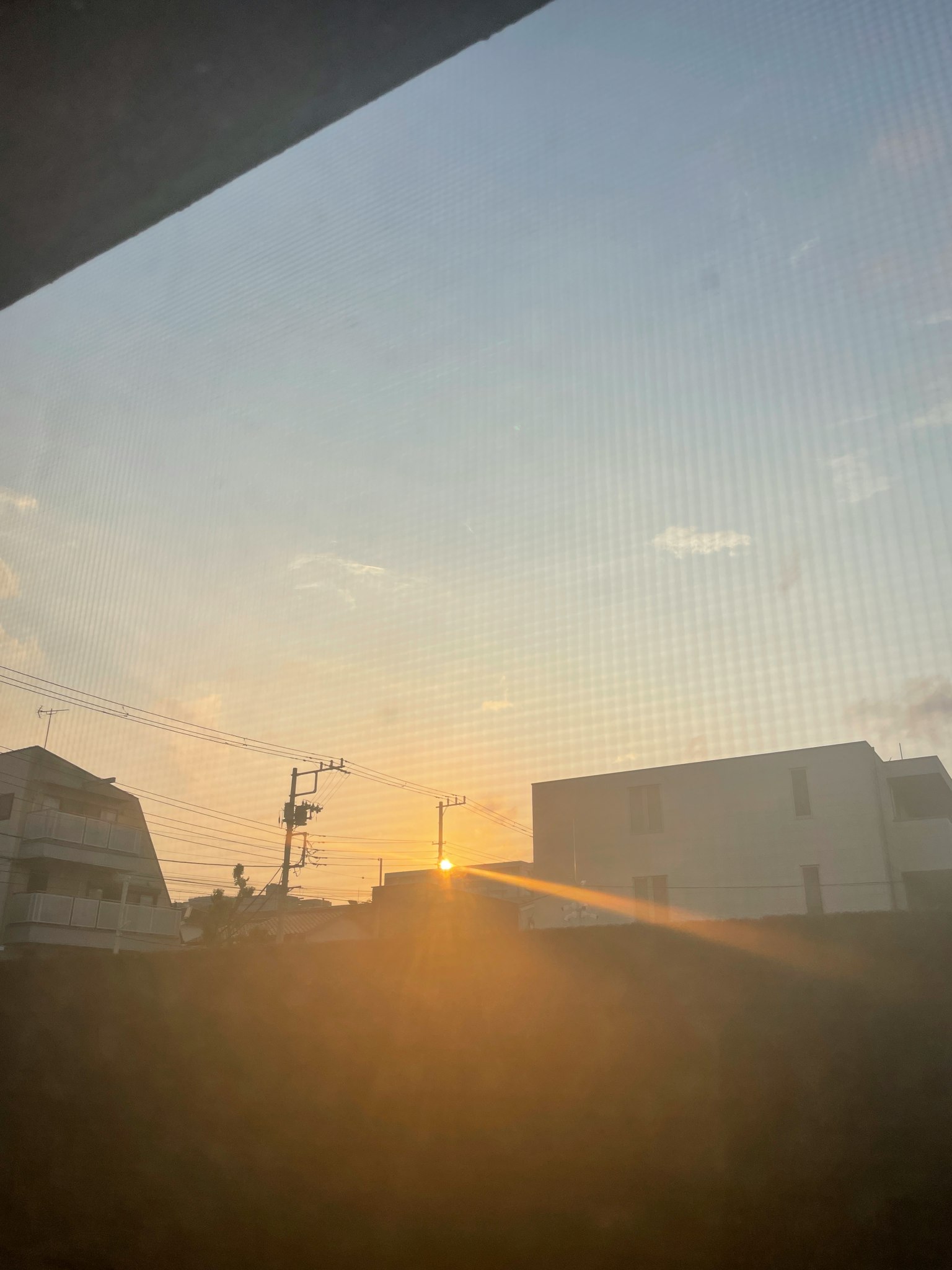 Vista del atardecer entre edificios con un suave resplandor