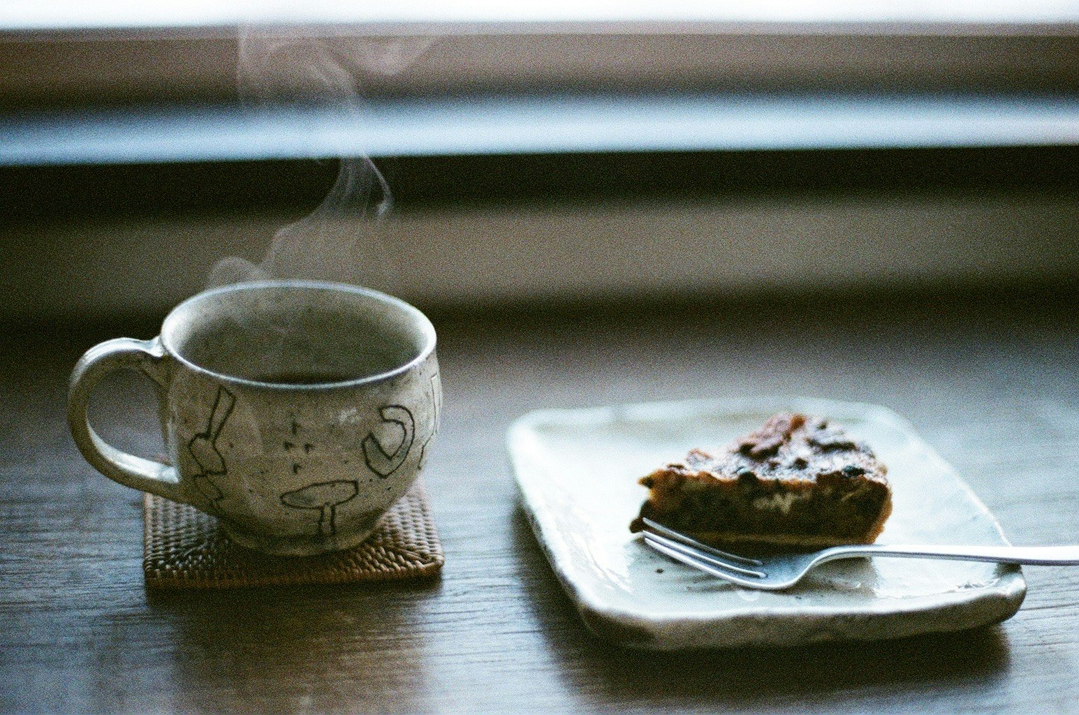 カップとケーキが並ぶカフェのテーブル上の静物