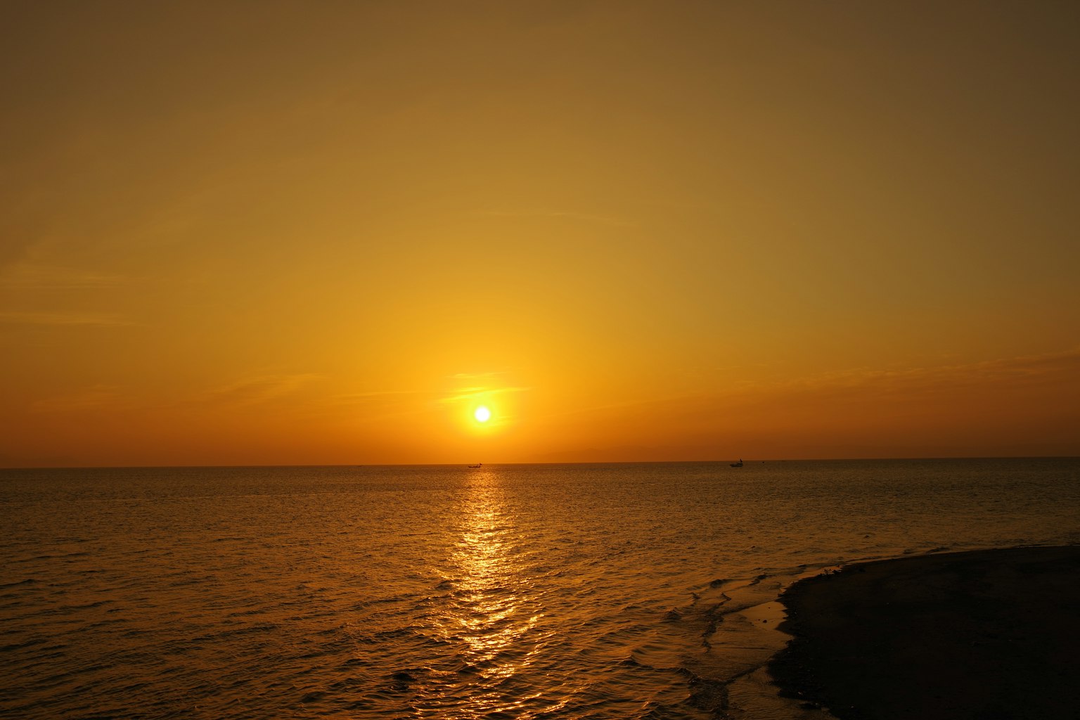 Beautiful sunset over the ocean with orange sky and reflective water