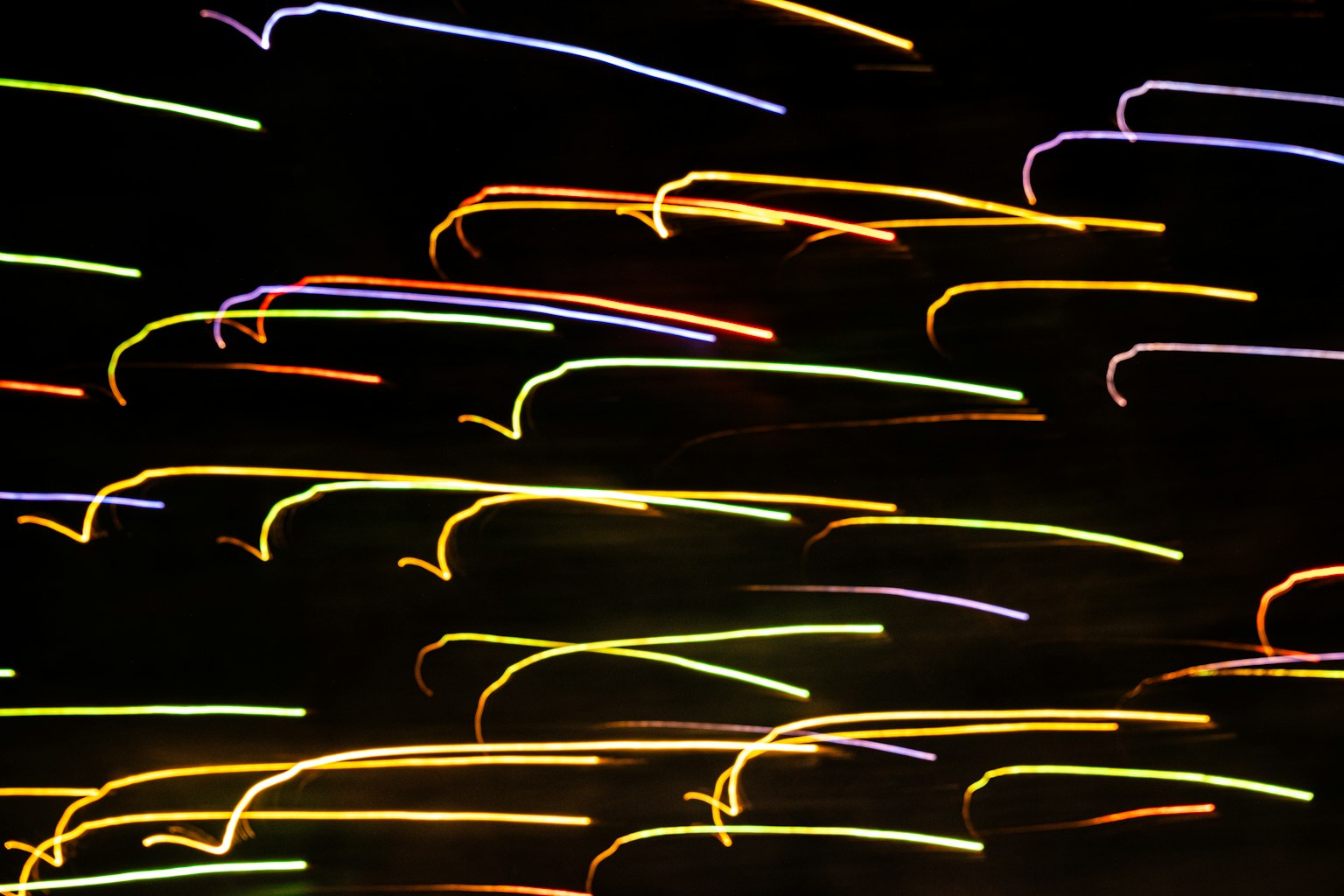 Abstract image of colorful light trails against a dark background