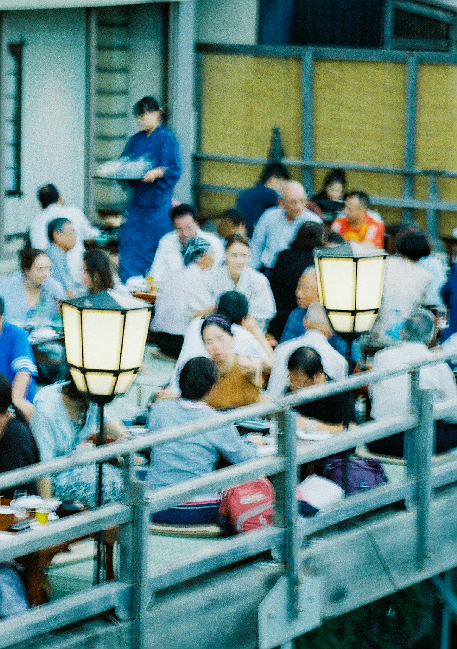 Lively outdoor dining scene with many people enjoying their meals