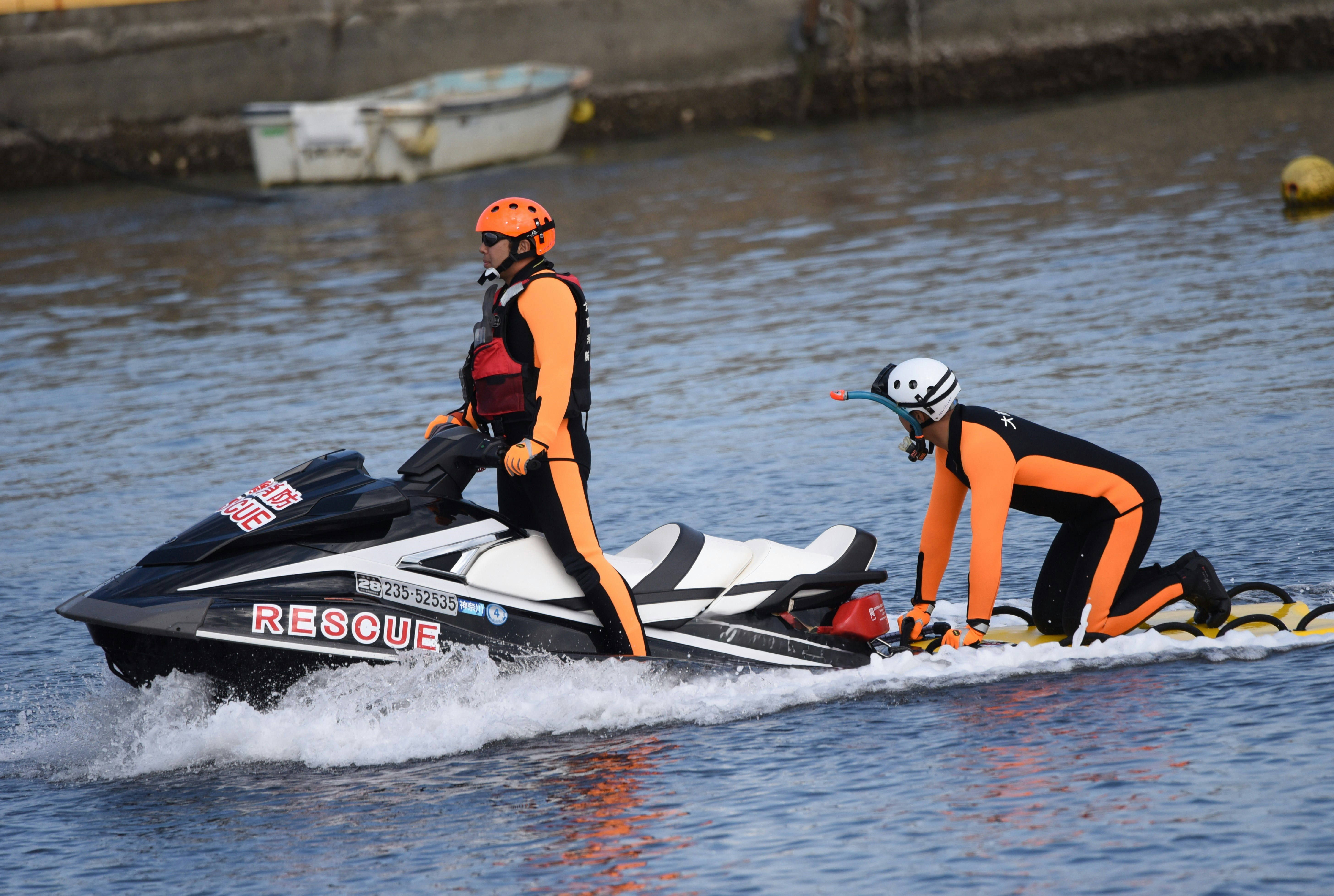 maritime rescue training with rescuers on a rescue boat and a dummy