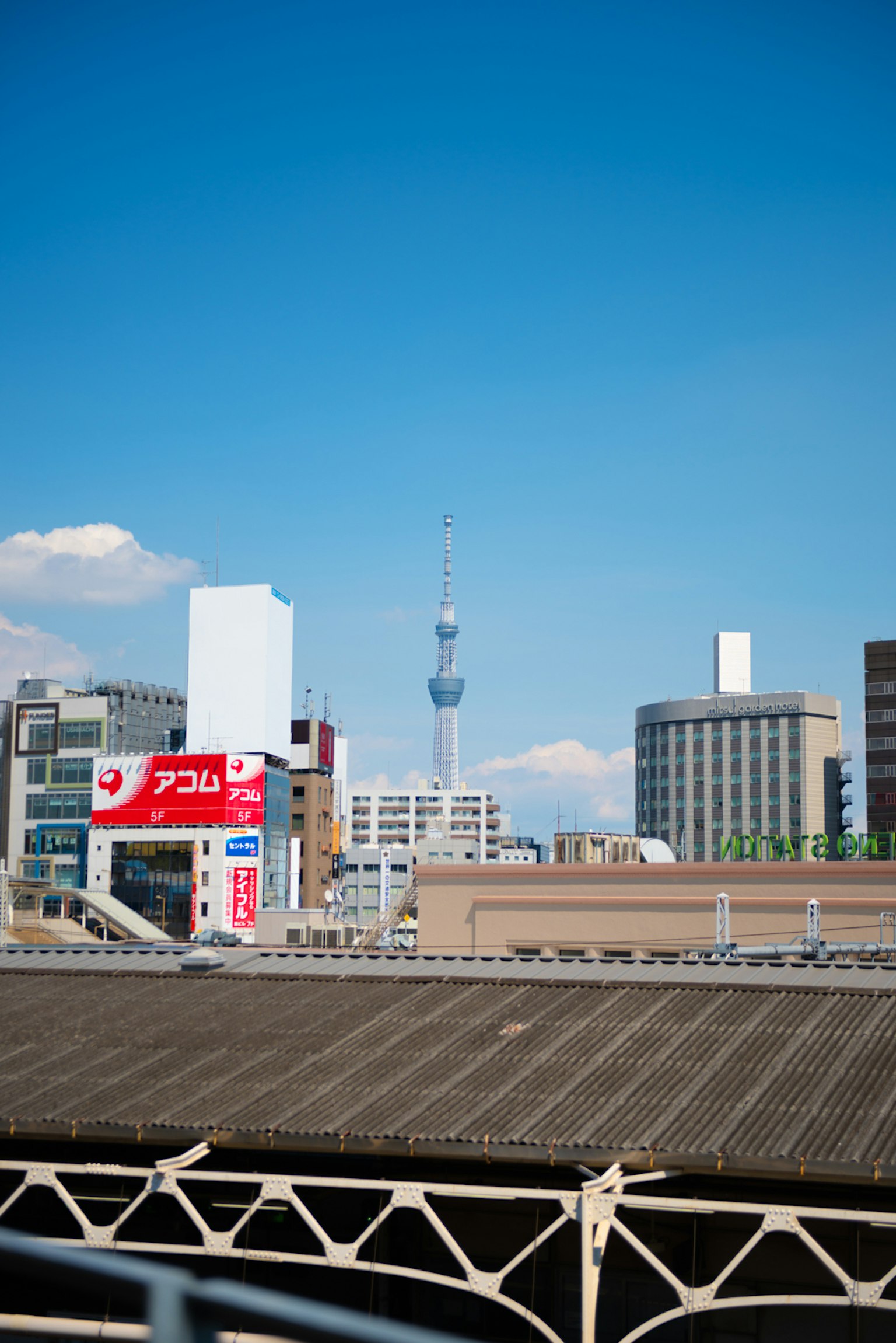 Cityscape featuring Tokyo Skytree bright blue sky and urban buildings