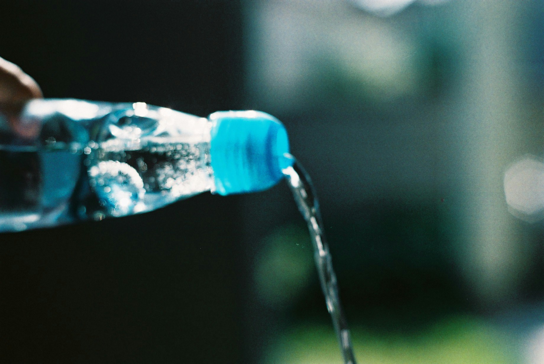 水が注がれる青いボトルのある水景