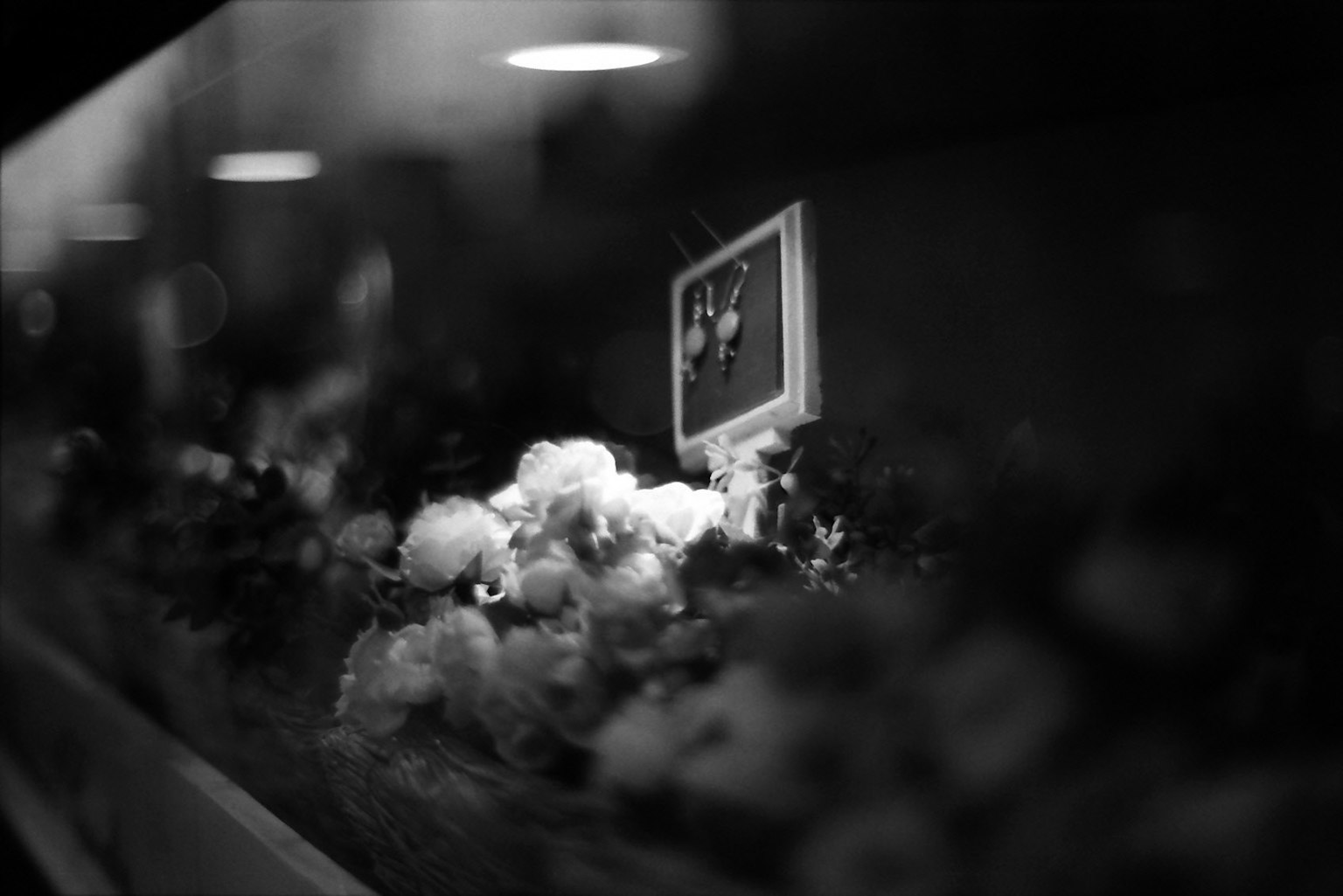 Black and white floral arrangement with a small picture frame