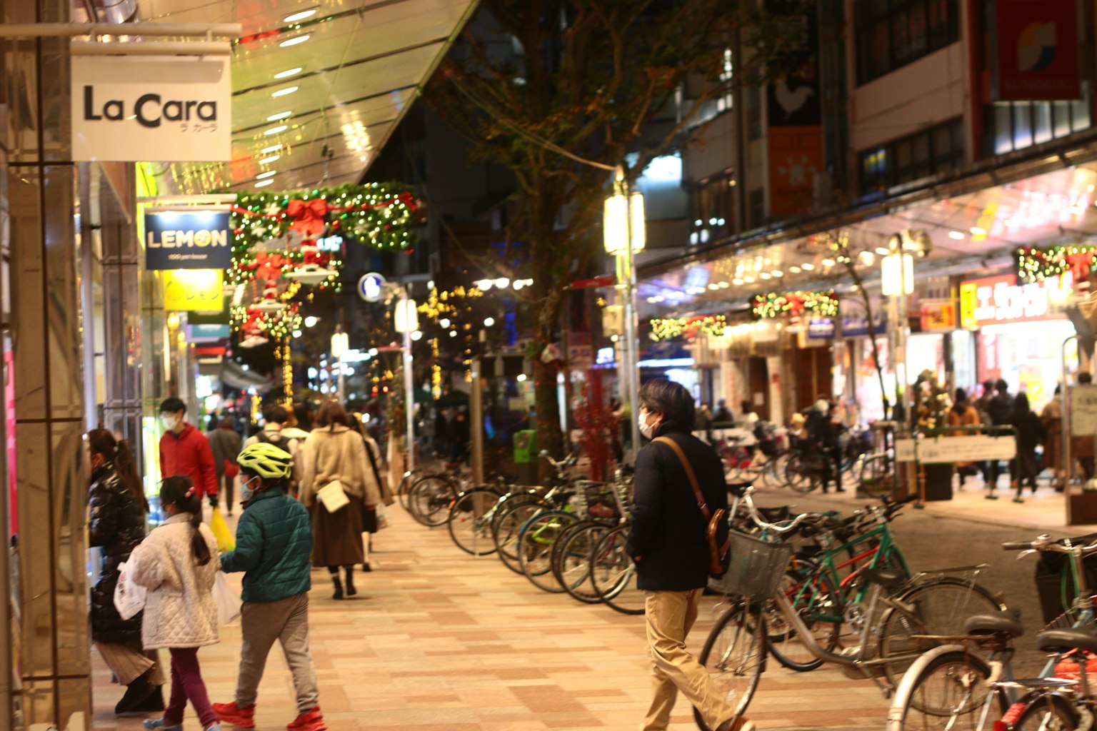 Nighttime street view with shops and bicycles
