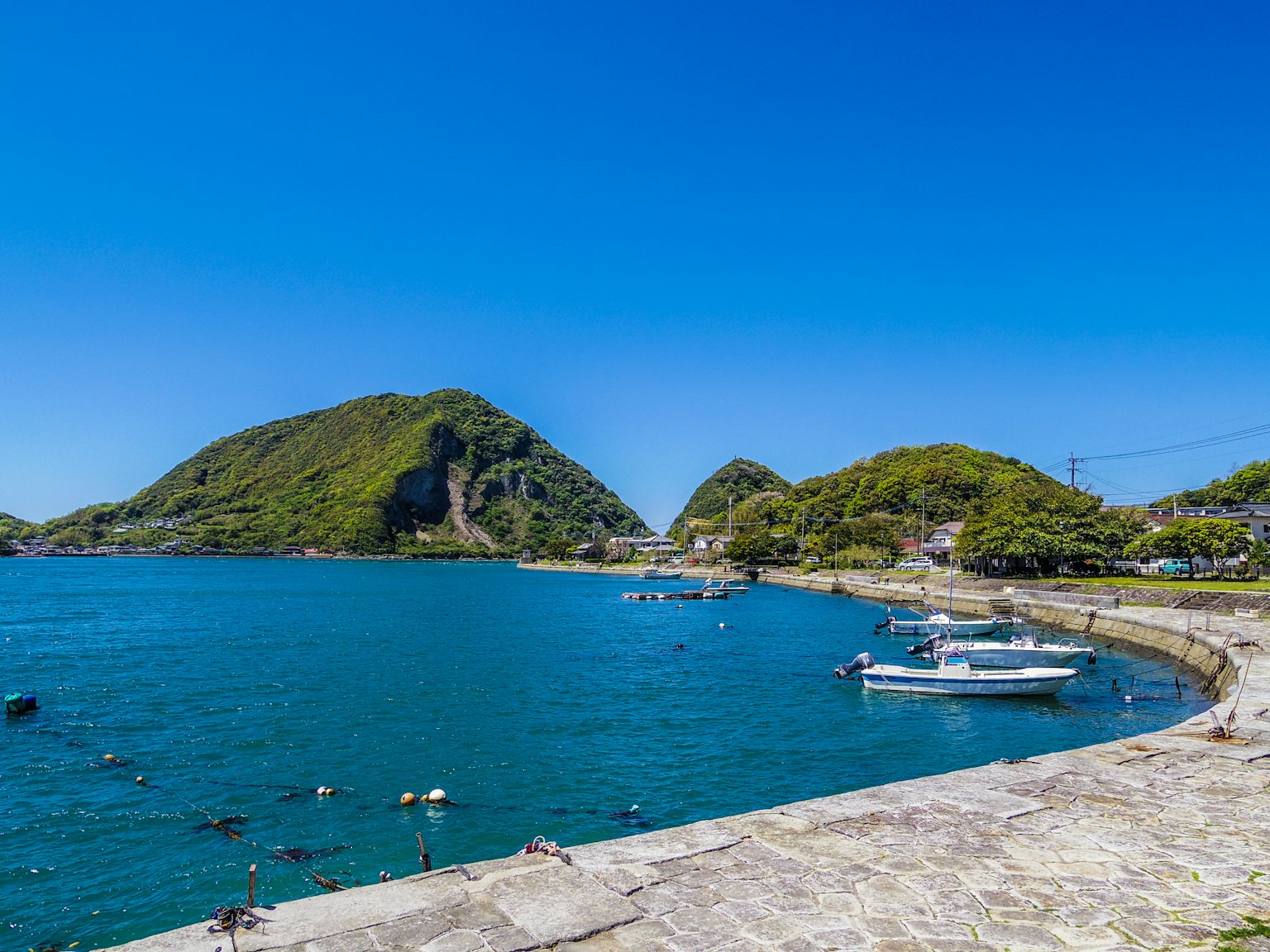 Vista panoramica di un porto con acqua blu e colline circostanti