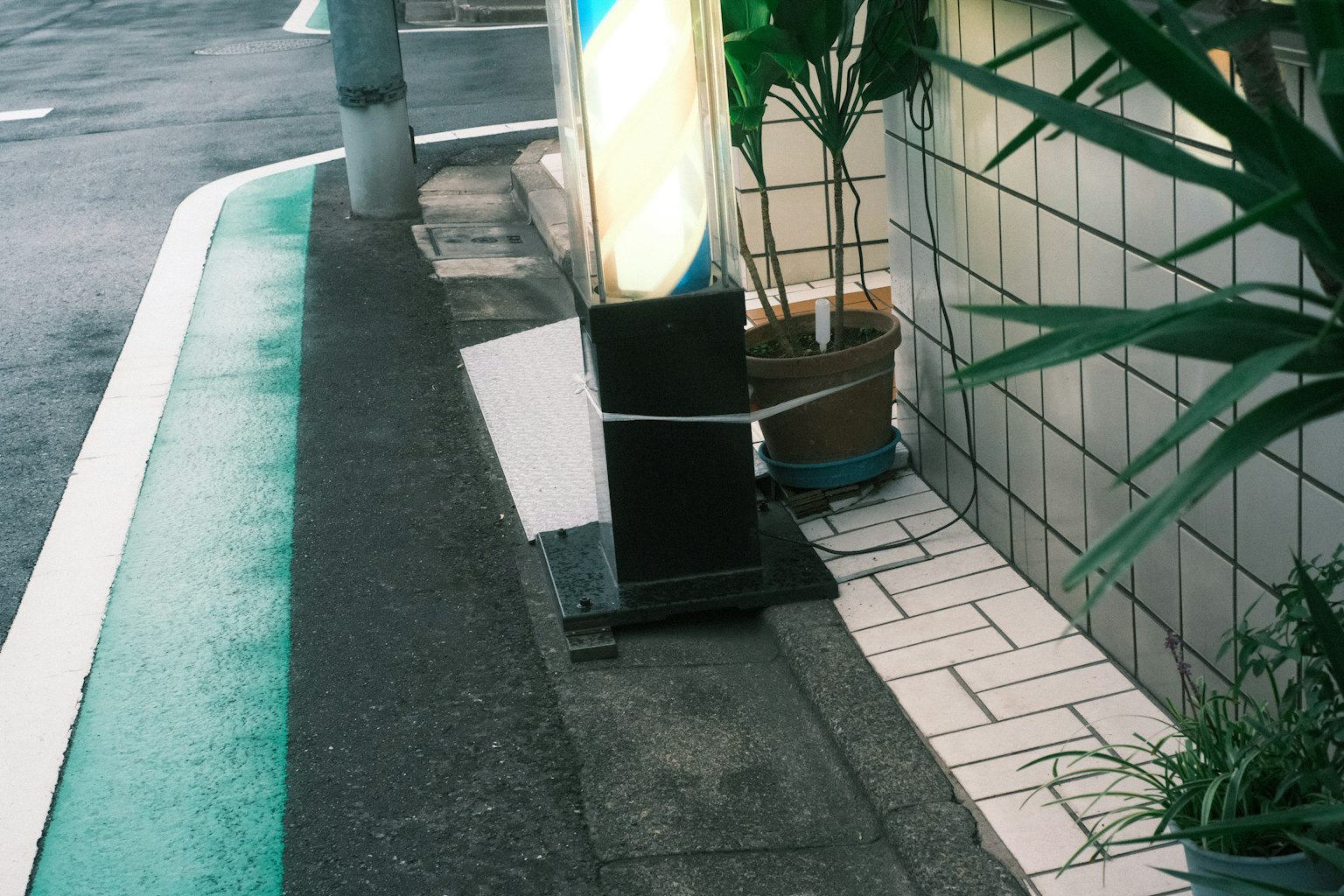 Coin de rue avec un panneau et une ligne verte sur le trottoir