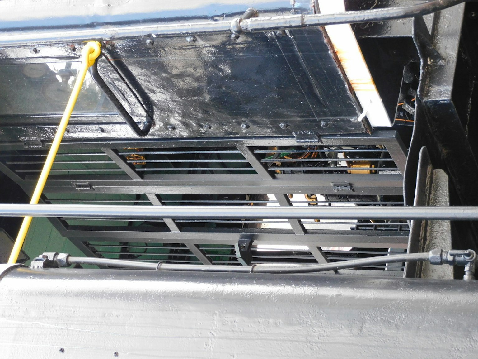 Image of a black metal structure with a yellow rope hanging down