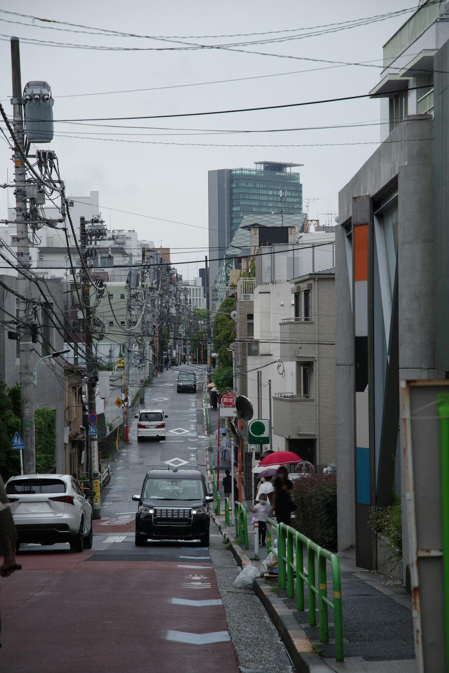 Urban street view featuring residential buildings and vehicles with skyscrapers in the background