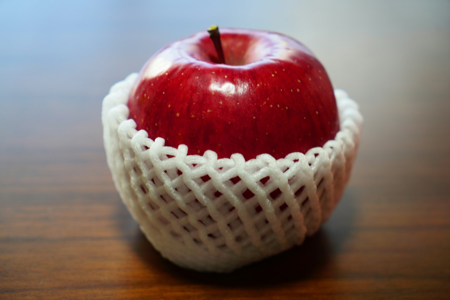 Manzana roja envuelta en una red blanca