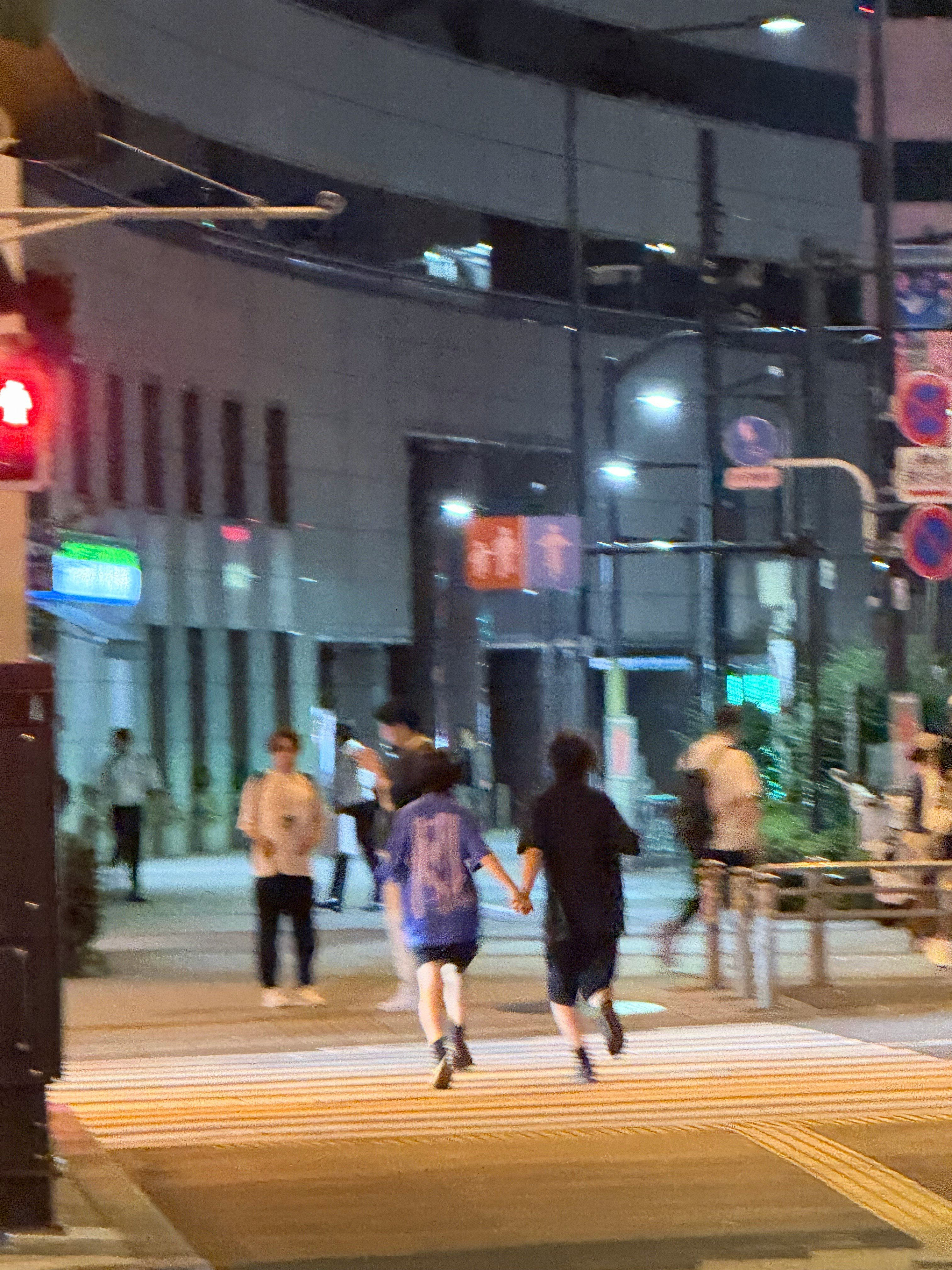 夜晚街道路口行人和交通信号灯