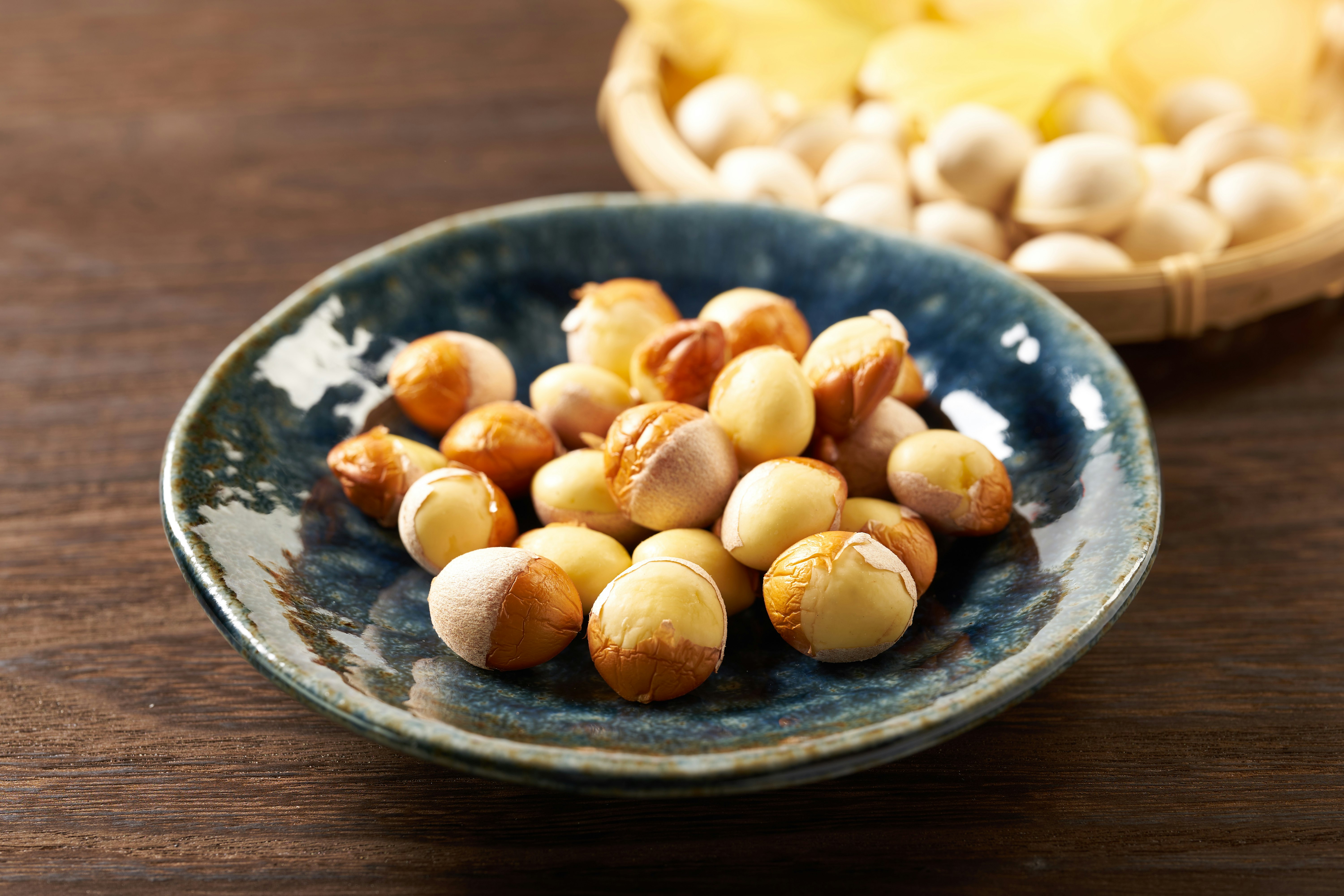 mixed nuts in a small bowl on a wooden table